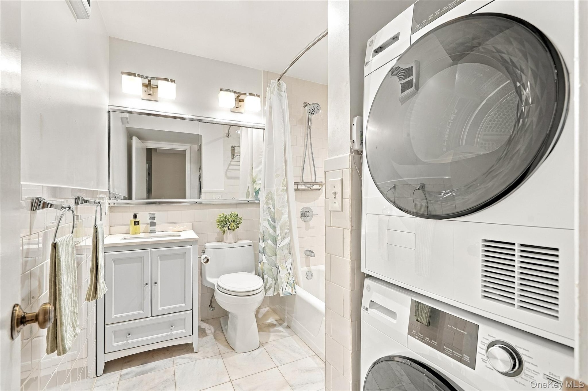 Brand new top of the line stackable GE washer and dryer fits conveniently into the full hall bath