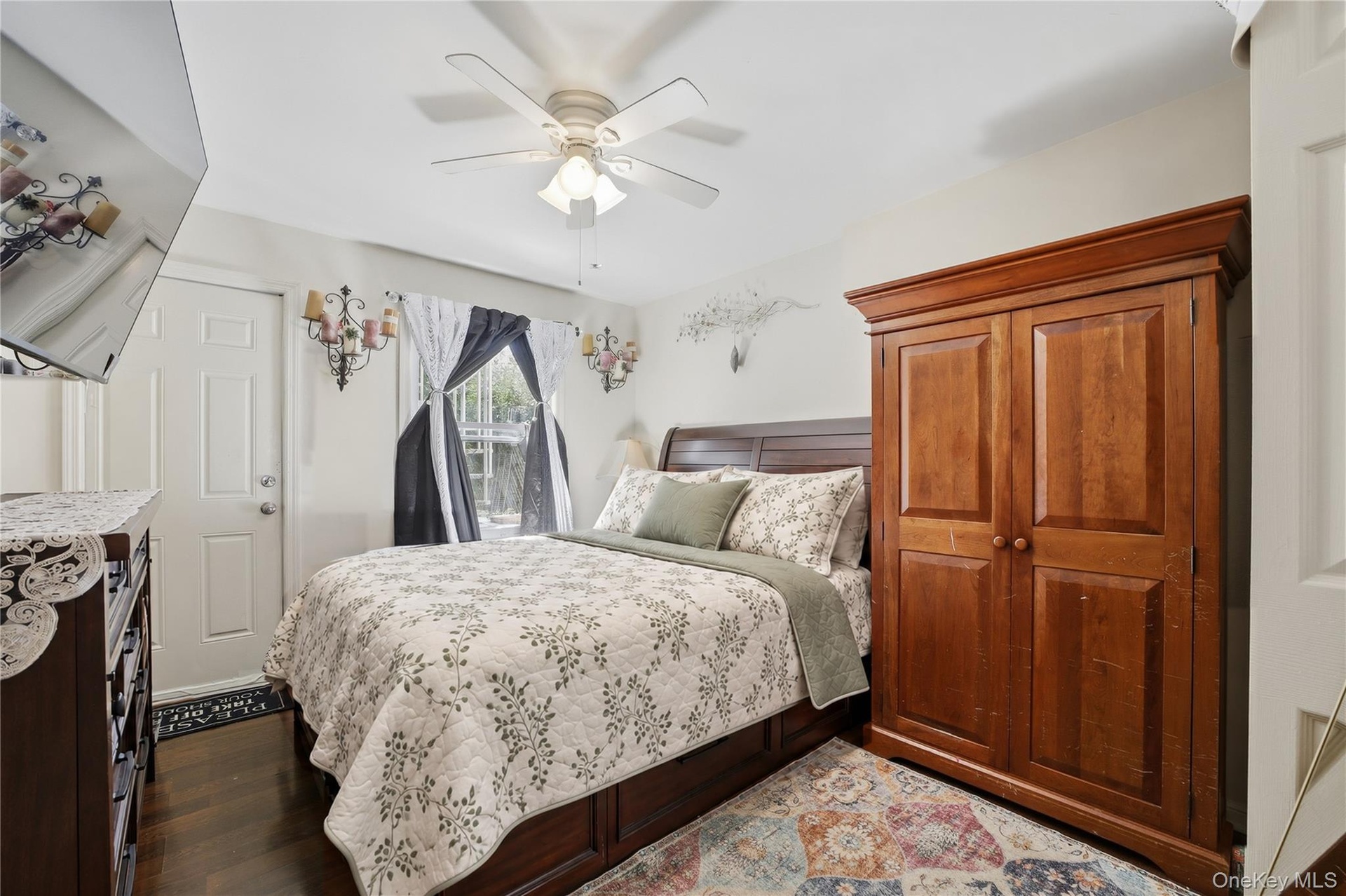 Unit 1 - Primary bedroom. Digitally decluttered; bedding and decor restyled.