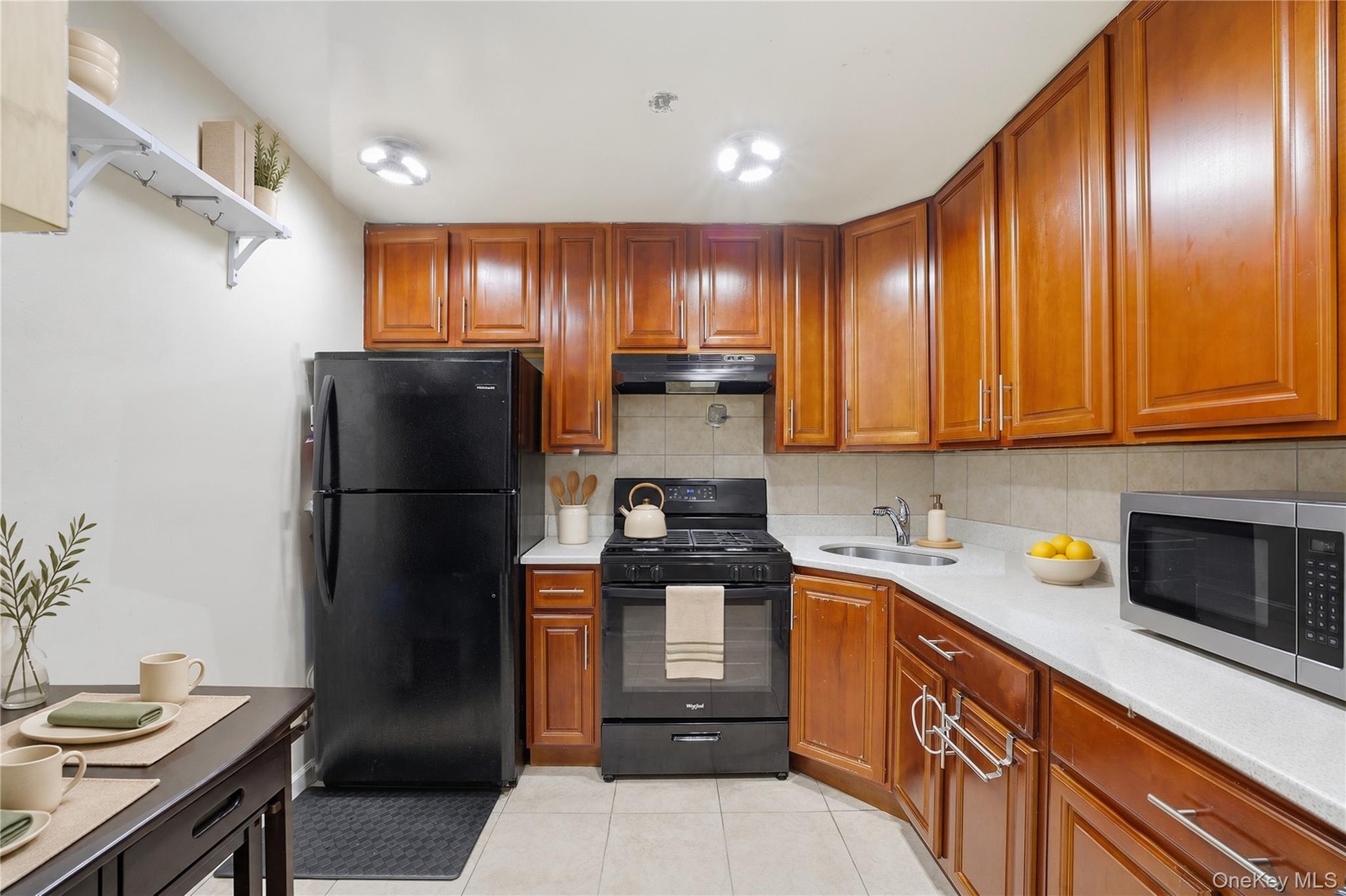 Unit 1 - Eat-in kitchen. Digitally decluttered; some decor restyled.