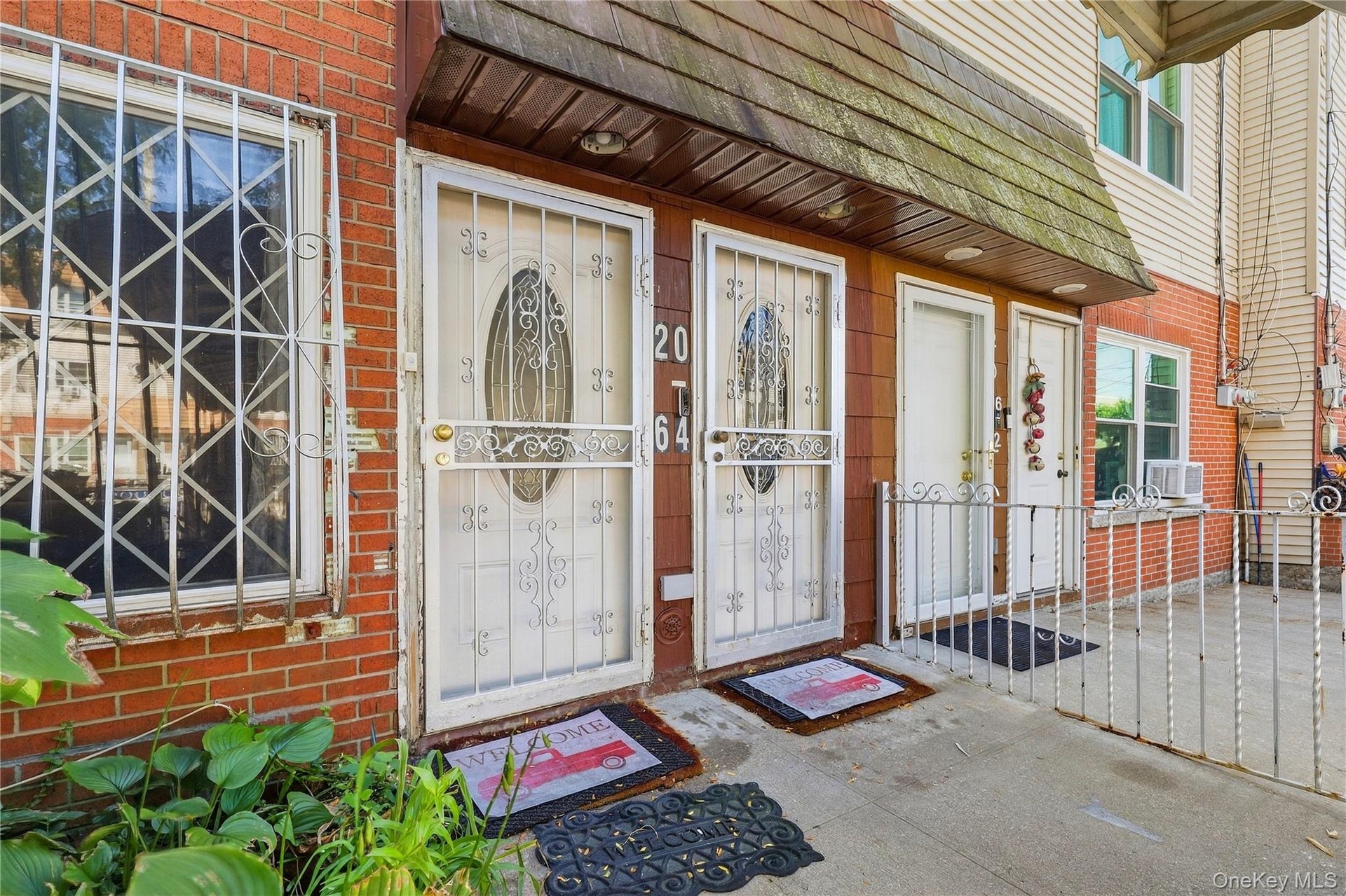 Front entrance detail. Digitally decluttered.