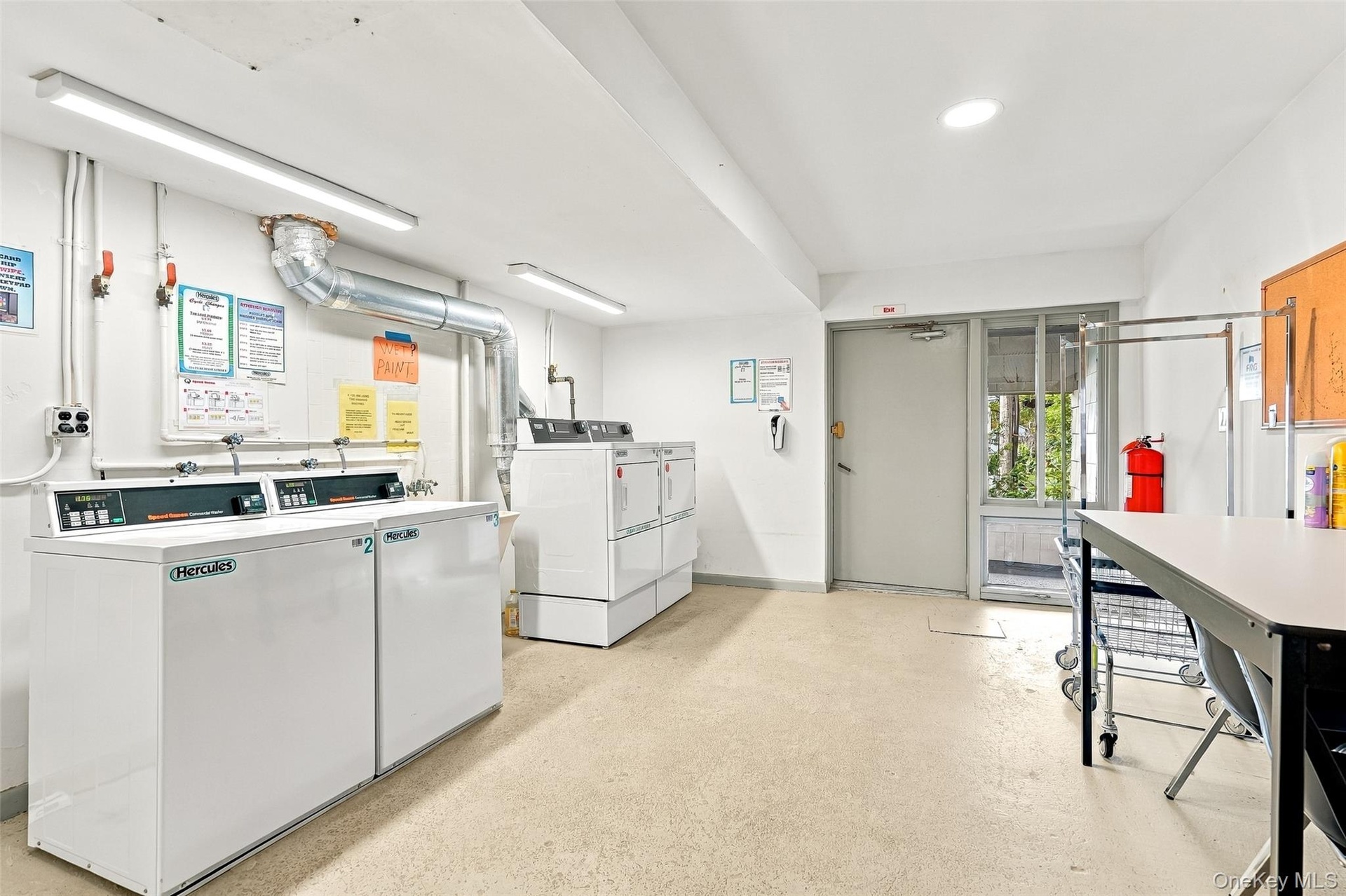 Supplemental bright and clean laundry facility is conveniently located one level down for co-op owners.