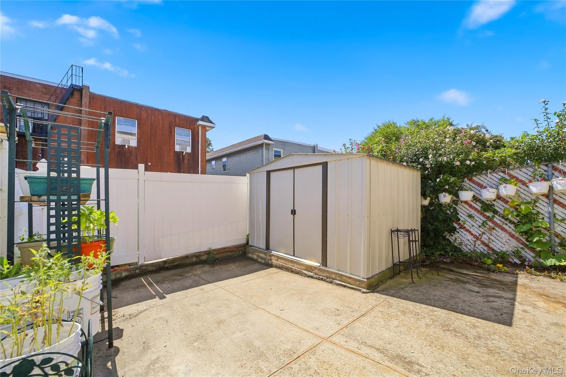 Backyard and storage shed, alternate view. Digitally decluttered.