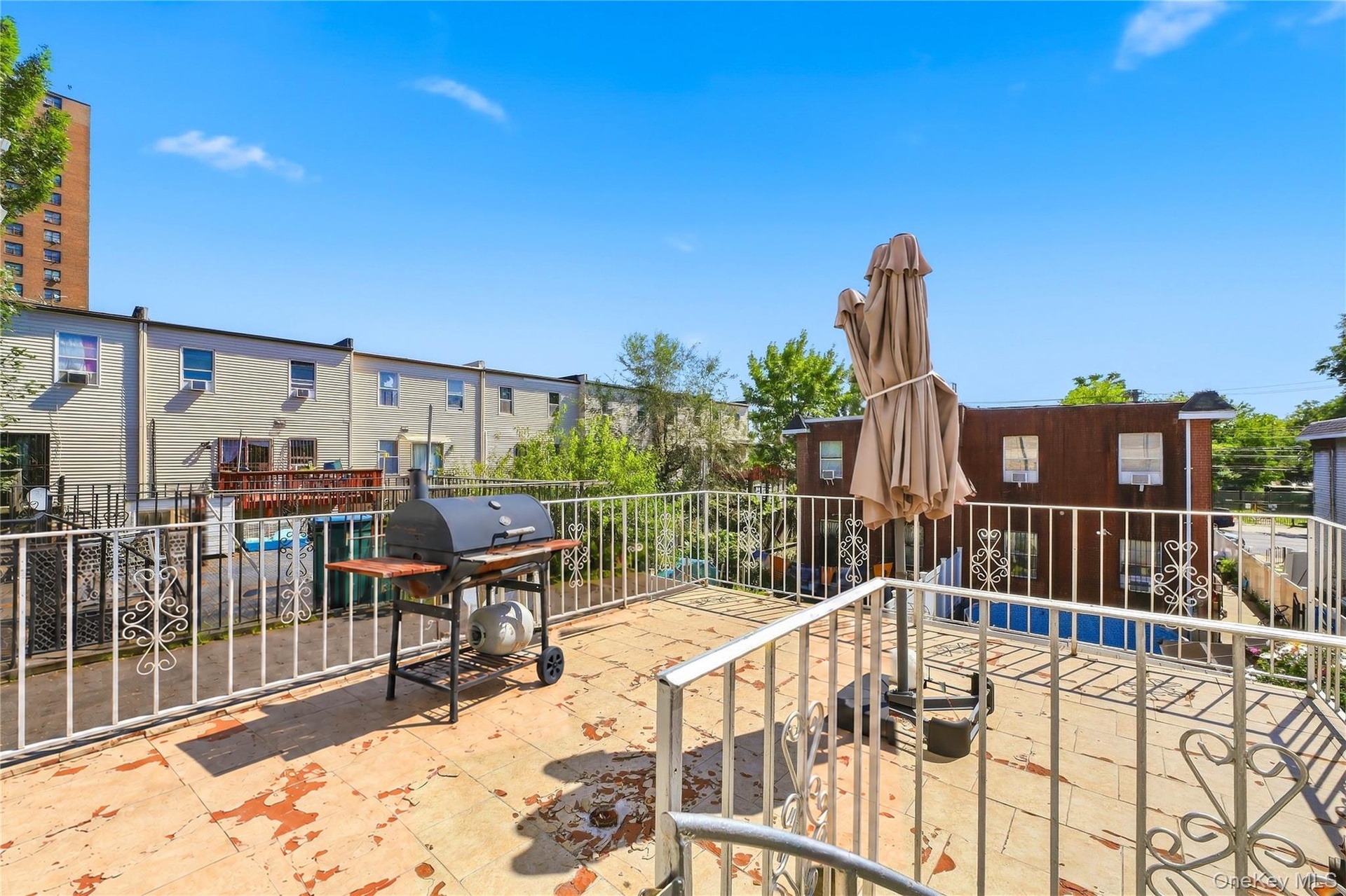 Rear balcony with the spiral staircase to the backyard. Digitally decluttered.