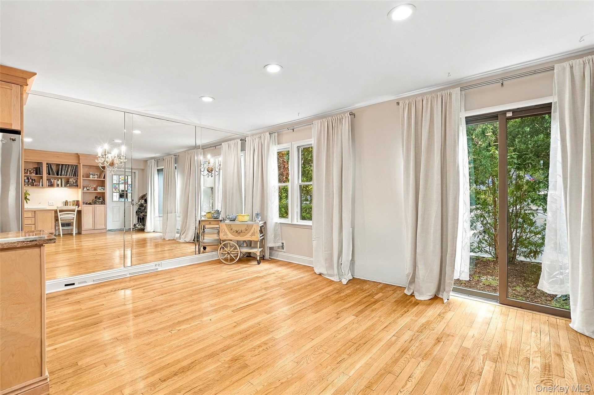 The mirrored wall makes the living space feel even larger than it is and the glass doors bring the outdoors in.