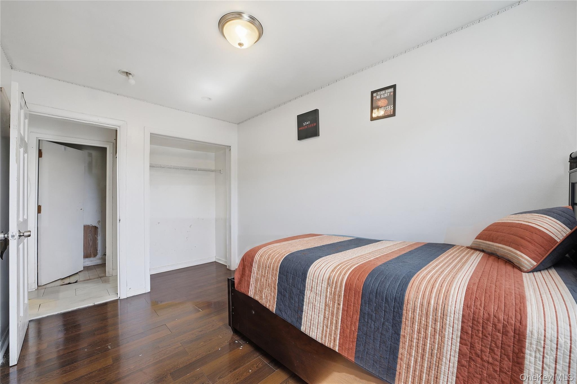 Unit 2 - Bedroom 3, closet and entrance view. Digitally decluttered; bedding and decor restyled.
