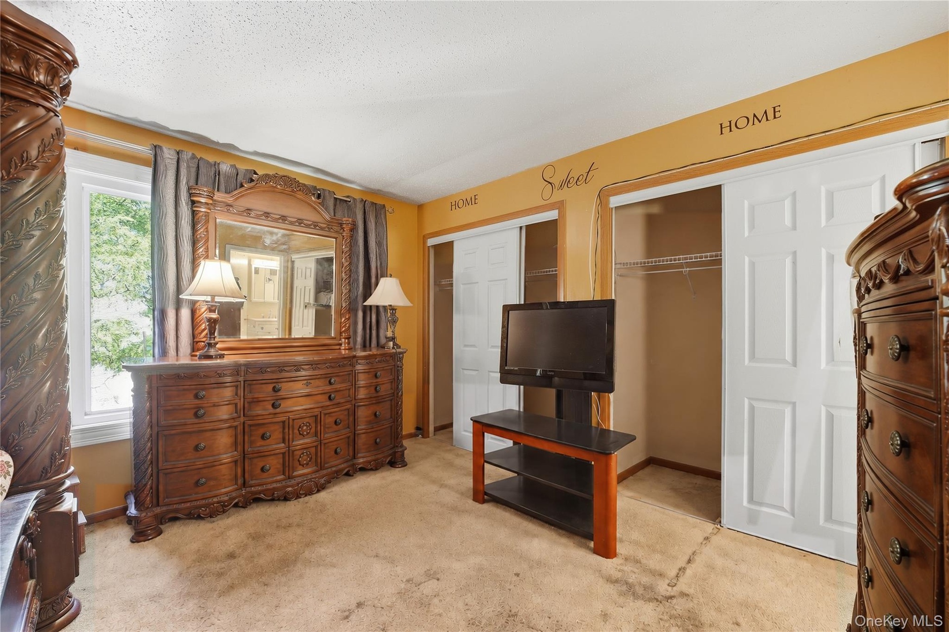 Unit 2 - Primary bedroom closets and dresser. Digitally decluttered; bedding and decor restyled.