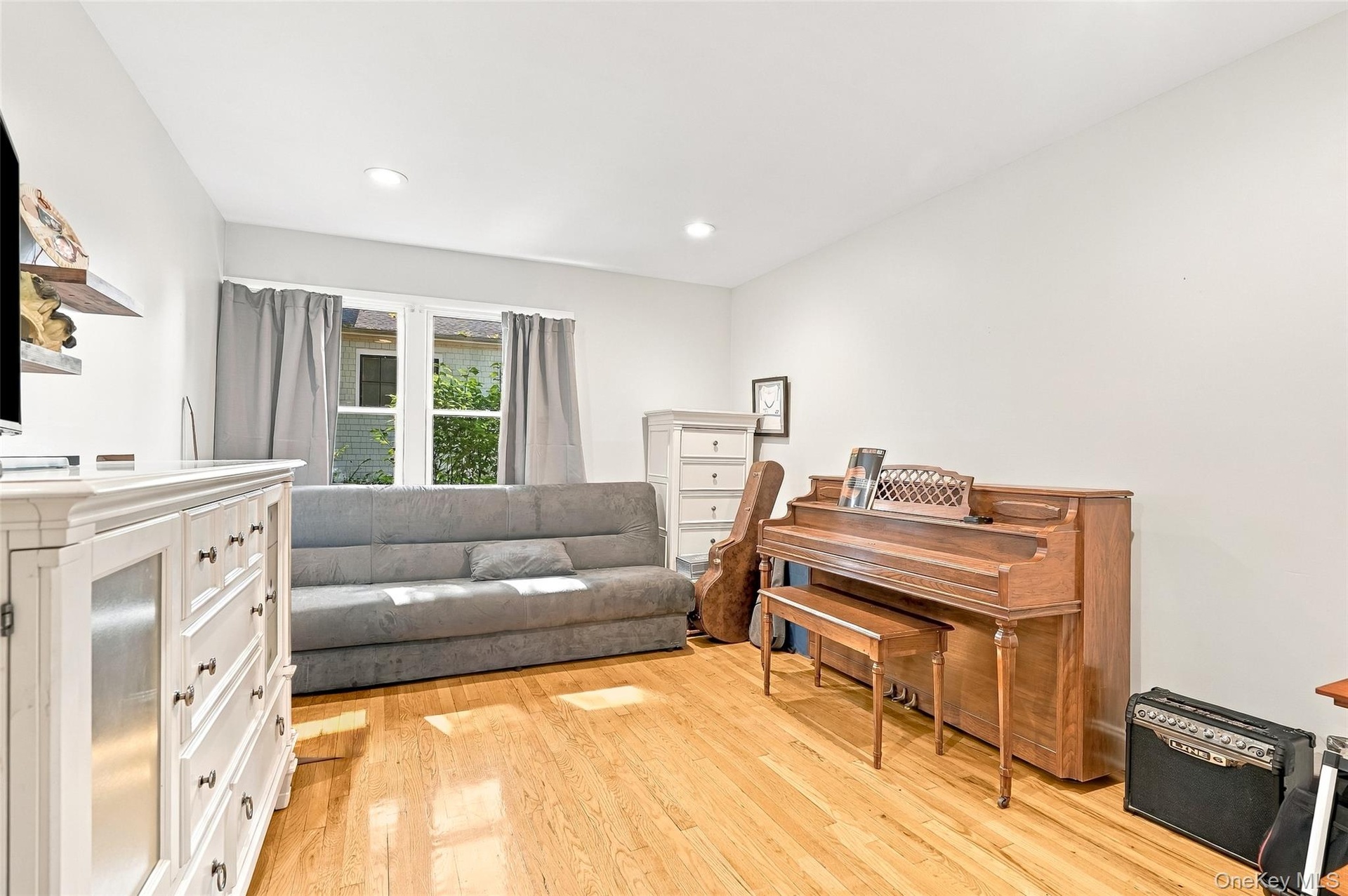 Generously proportioned 2nd bedroom easily transforms into second TV room/Den, Music Room.