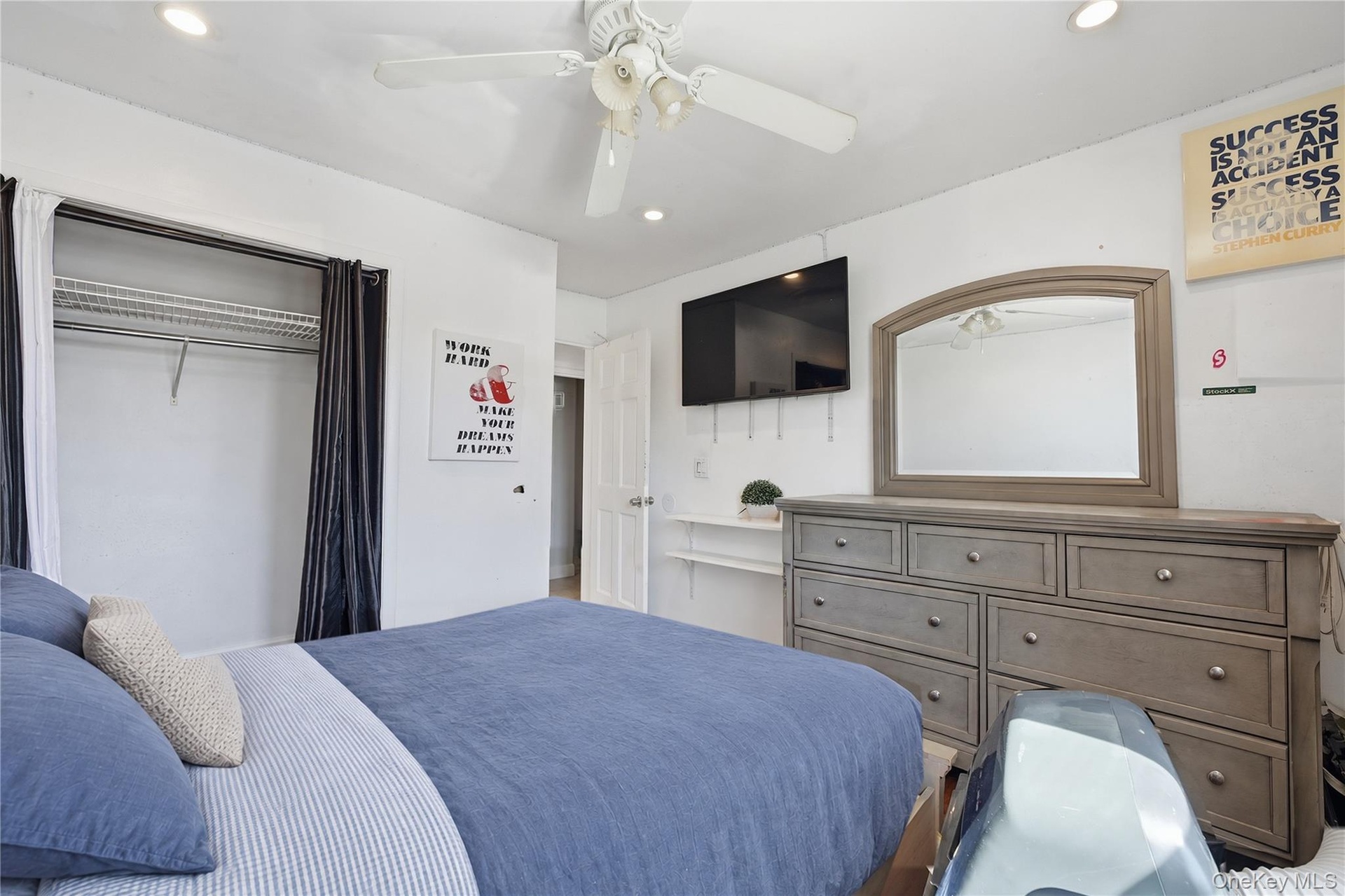 Unit 2 - Bedroom 2, closet view. Digitally decluttered; bedding and decor restyled.