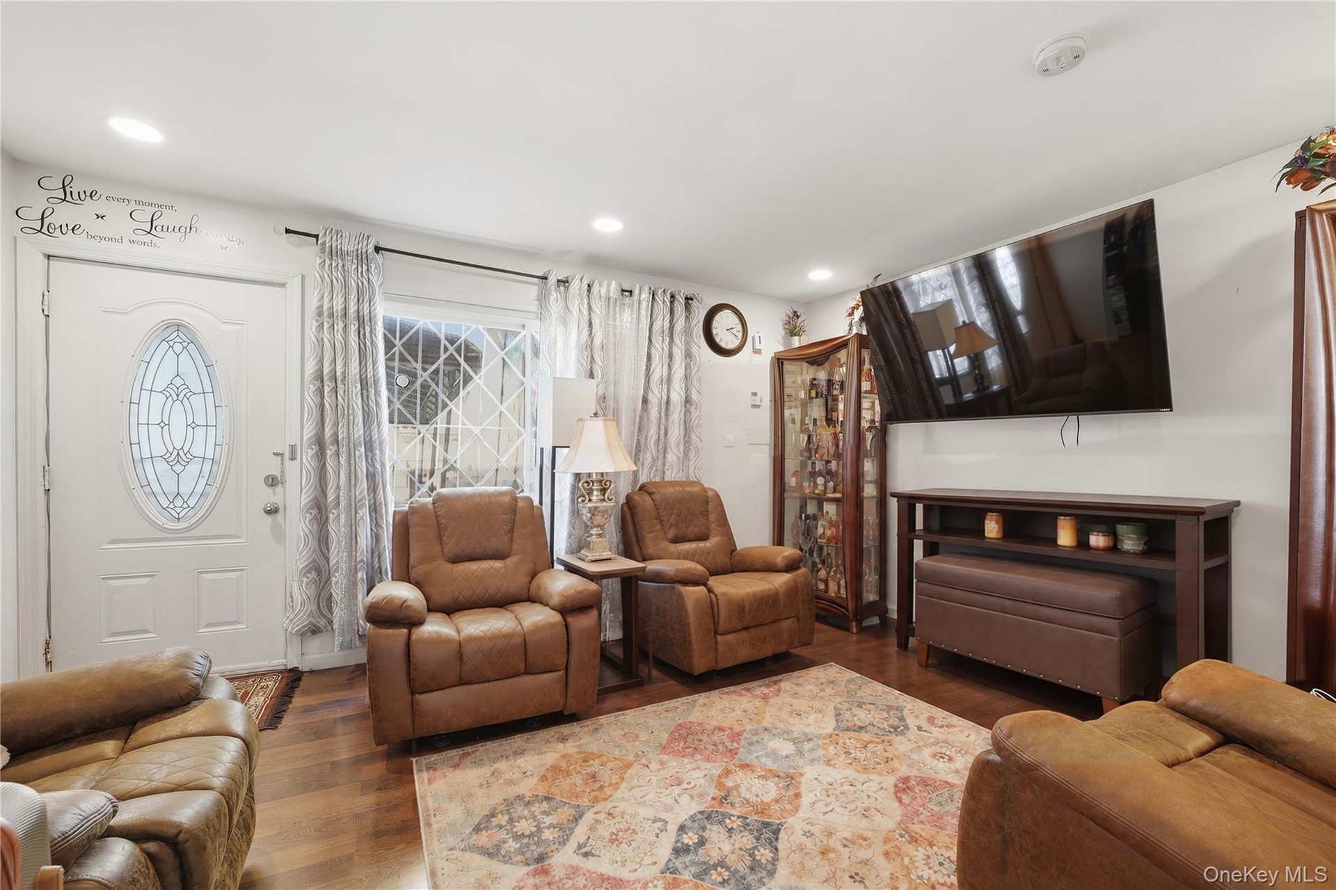 Unit 1 - Separate apartment living room. Digitally decluttered; some decor restyled.