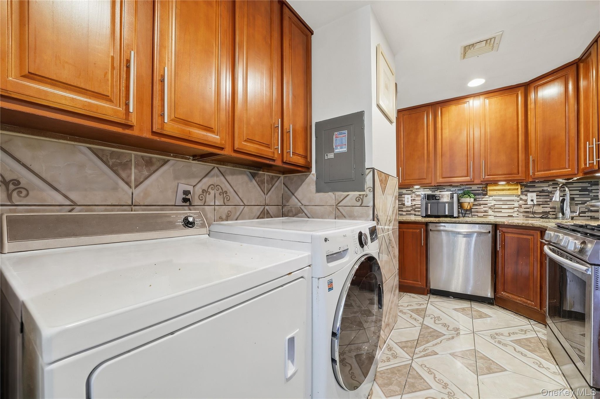 Unit 2 - Kitchen and in-unit laundry. Digitally decluttered.