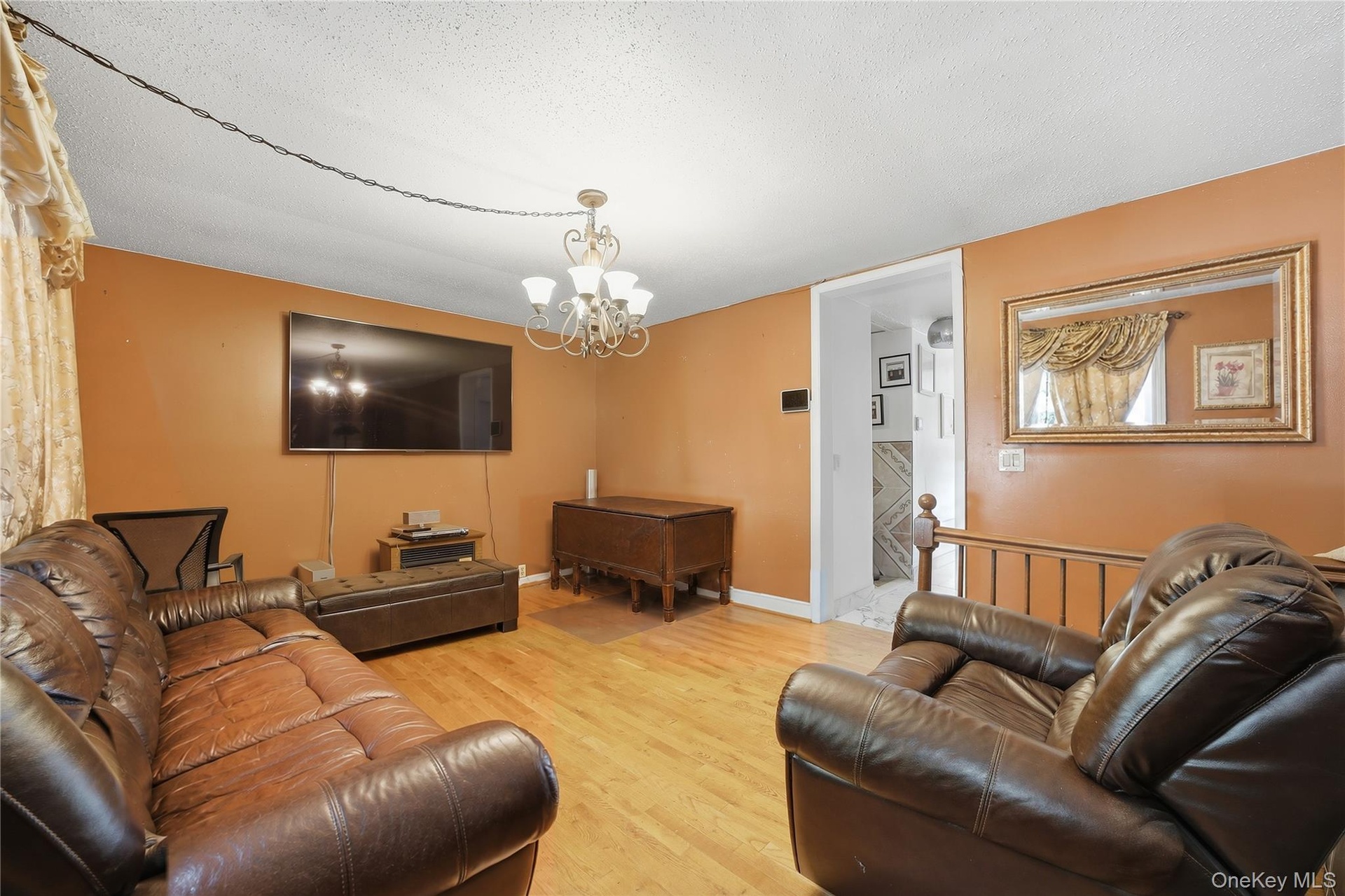 Unit 2 - Duplex living room, reverse view. Digitally decluttered; some decor restyled.