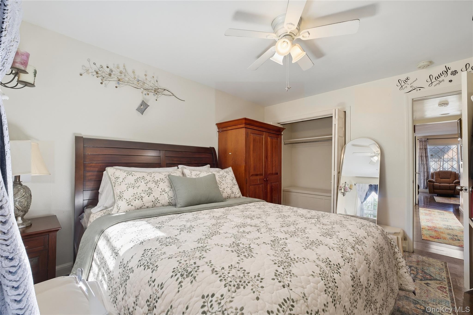 Unit 1 - Primary bedroom, reverse view. Digitally decluttered; bedding and decor restyled.