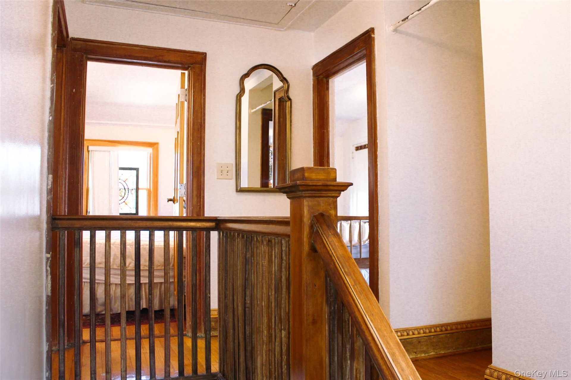 Wood-finish flooring, wood staircase with balusters, and wood door frames