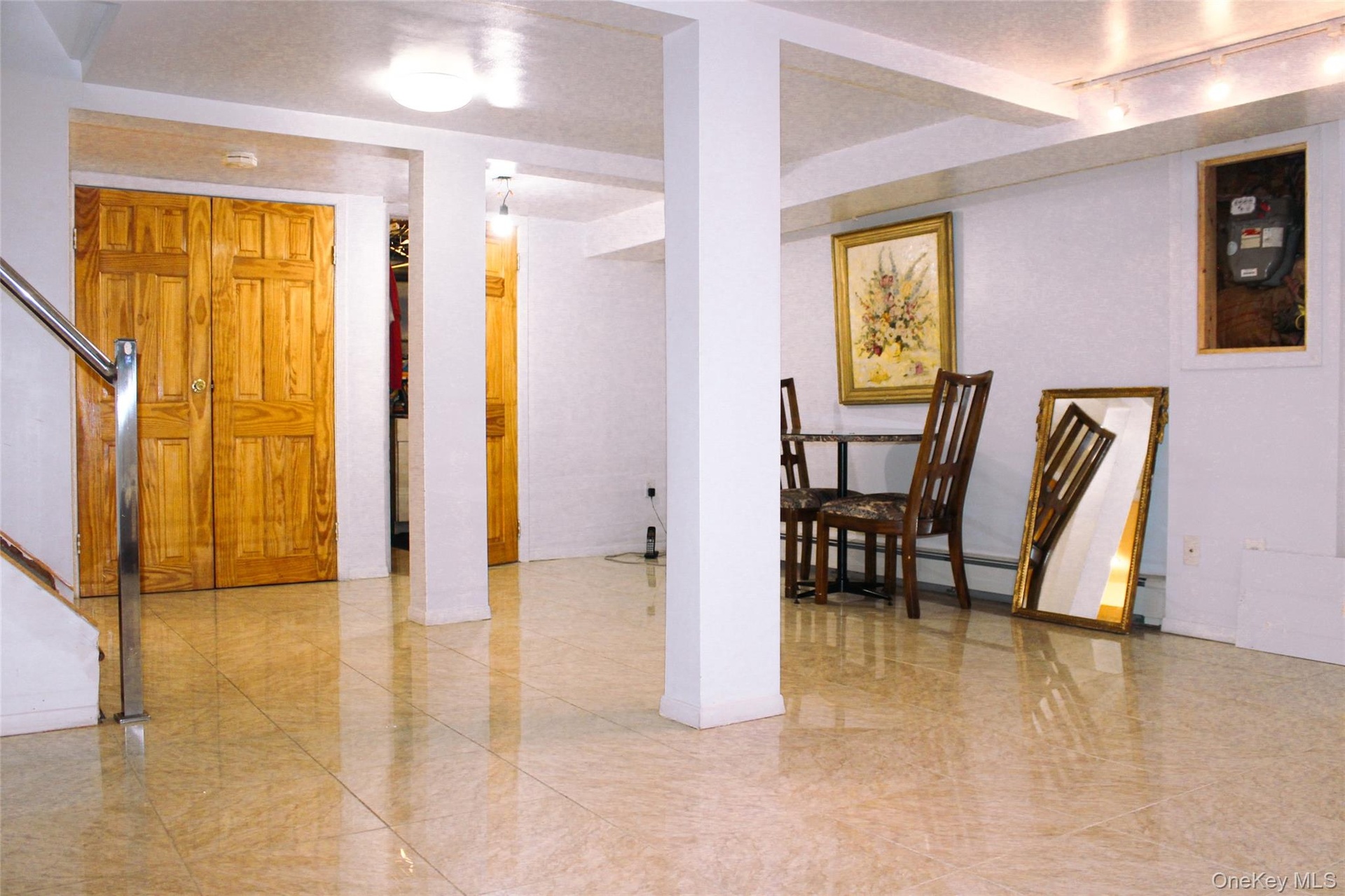 Light-toned tile flooring throughout basement