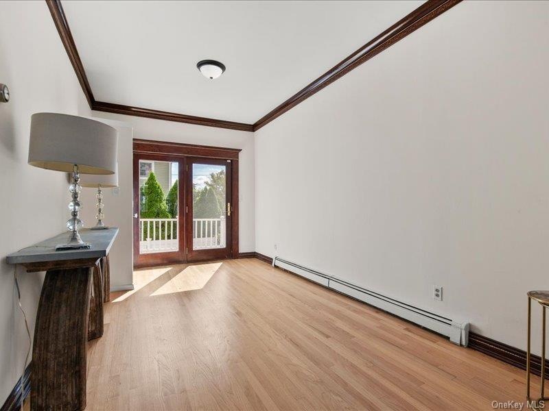Spacious living room opens to dining room. with glass doors to rear deck