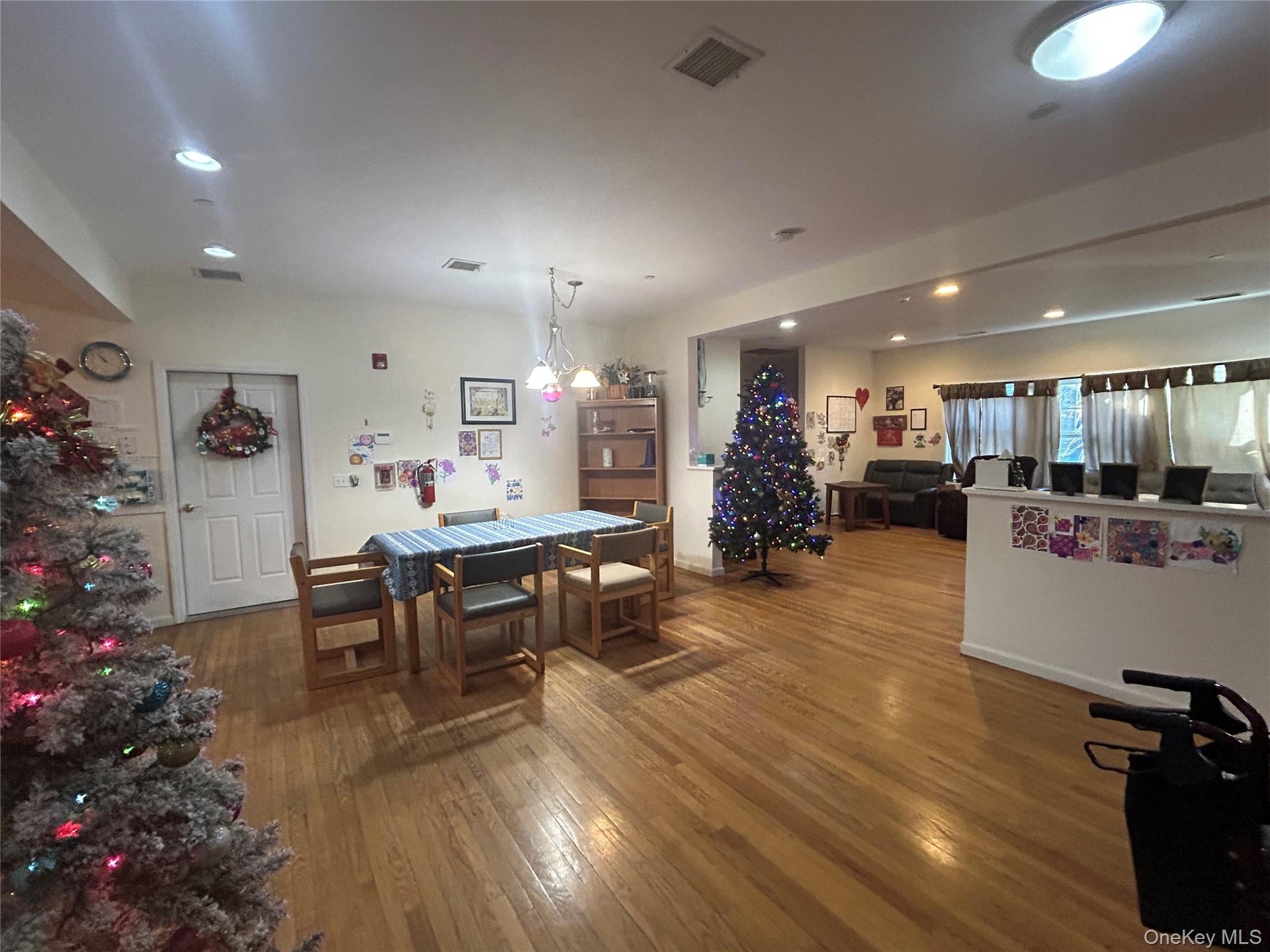 Dining room with dark wood-style floors and recessed lighting