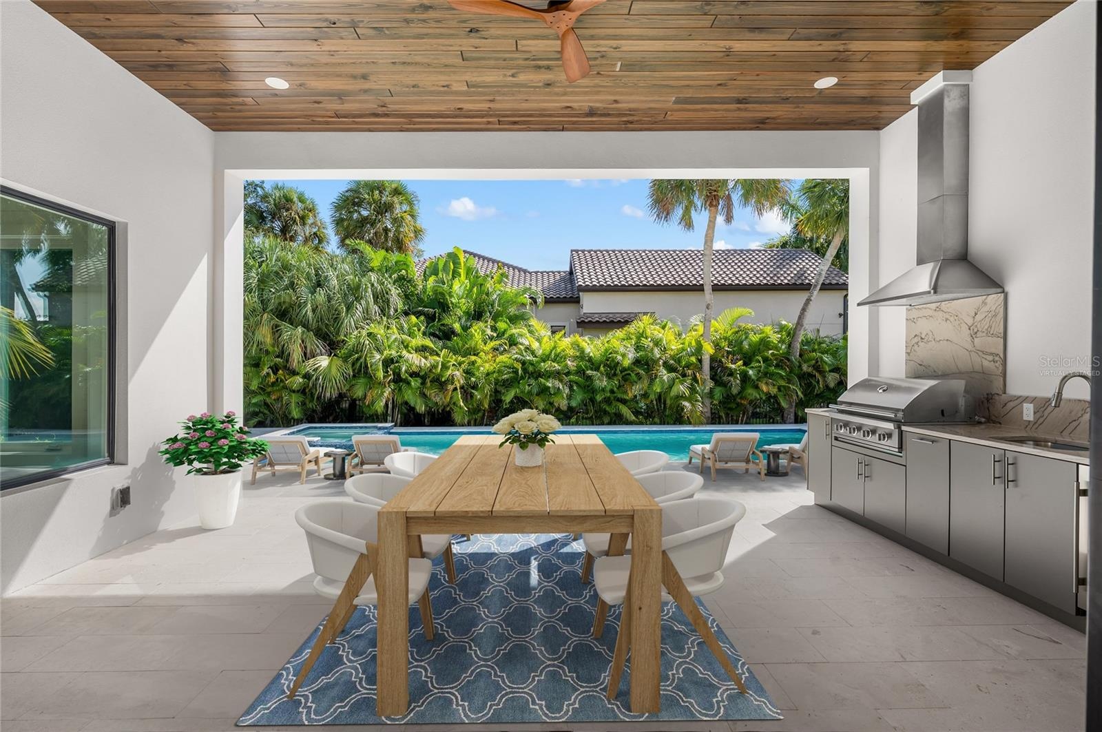 Virtually staged, paradise awaits in the under roof outdoor entertaining area with built in luxury kitchen.