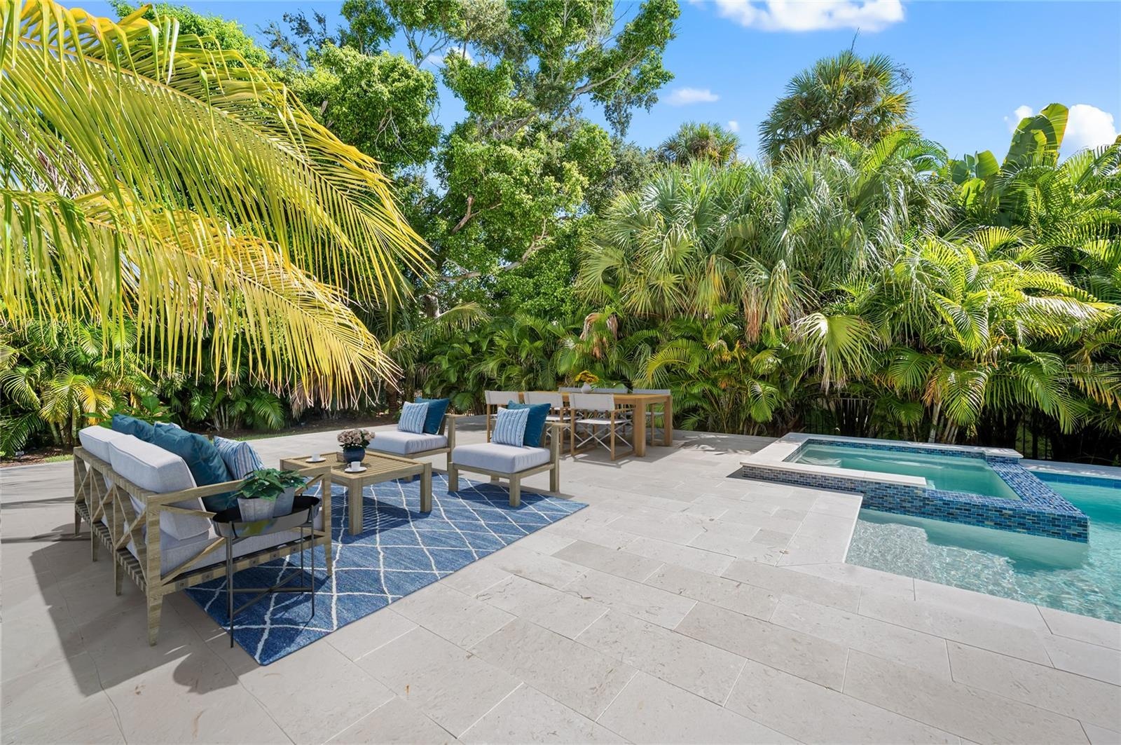 Virtually staged additional gathering space on pool deck in fenced and private back yard.