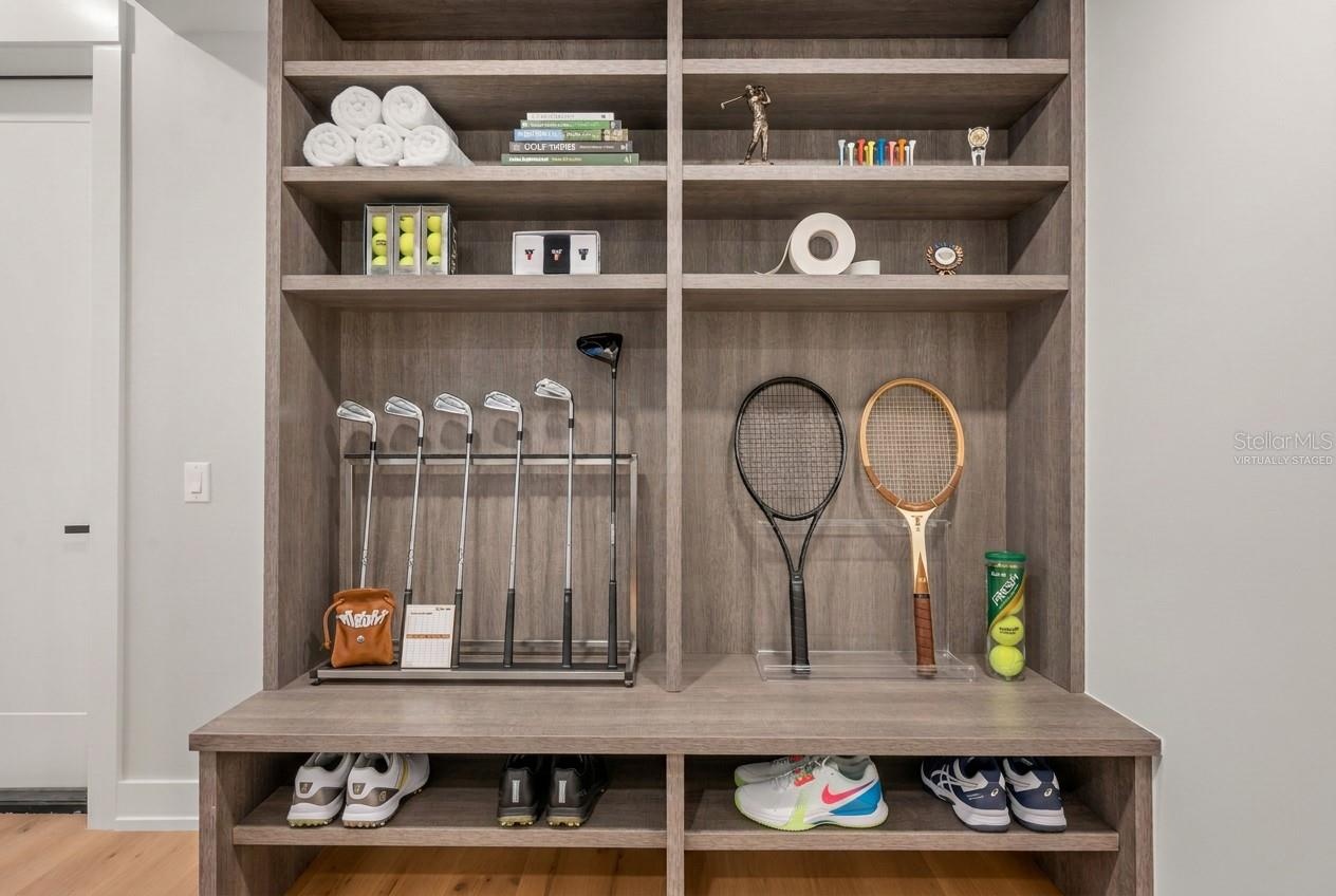 Virtually staged mudroom entry featuring custom built-ins with abundant storage for an active lifestyle.