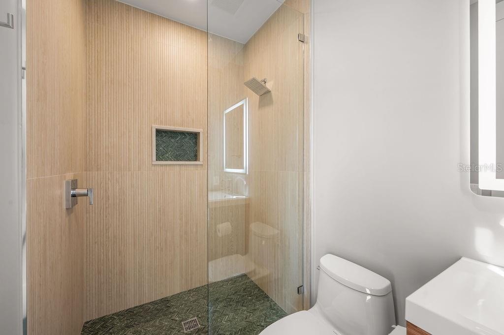 5th bedroom en suite features this custom designed walk in shower.