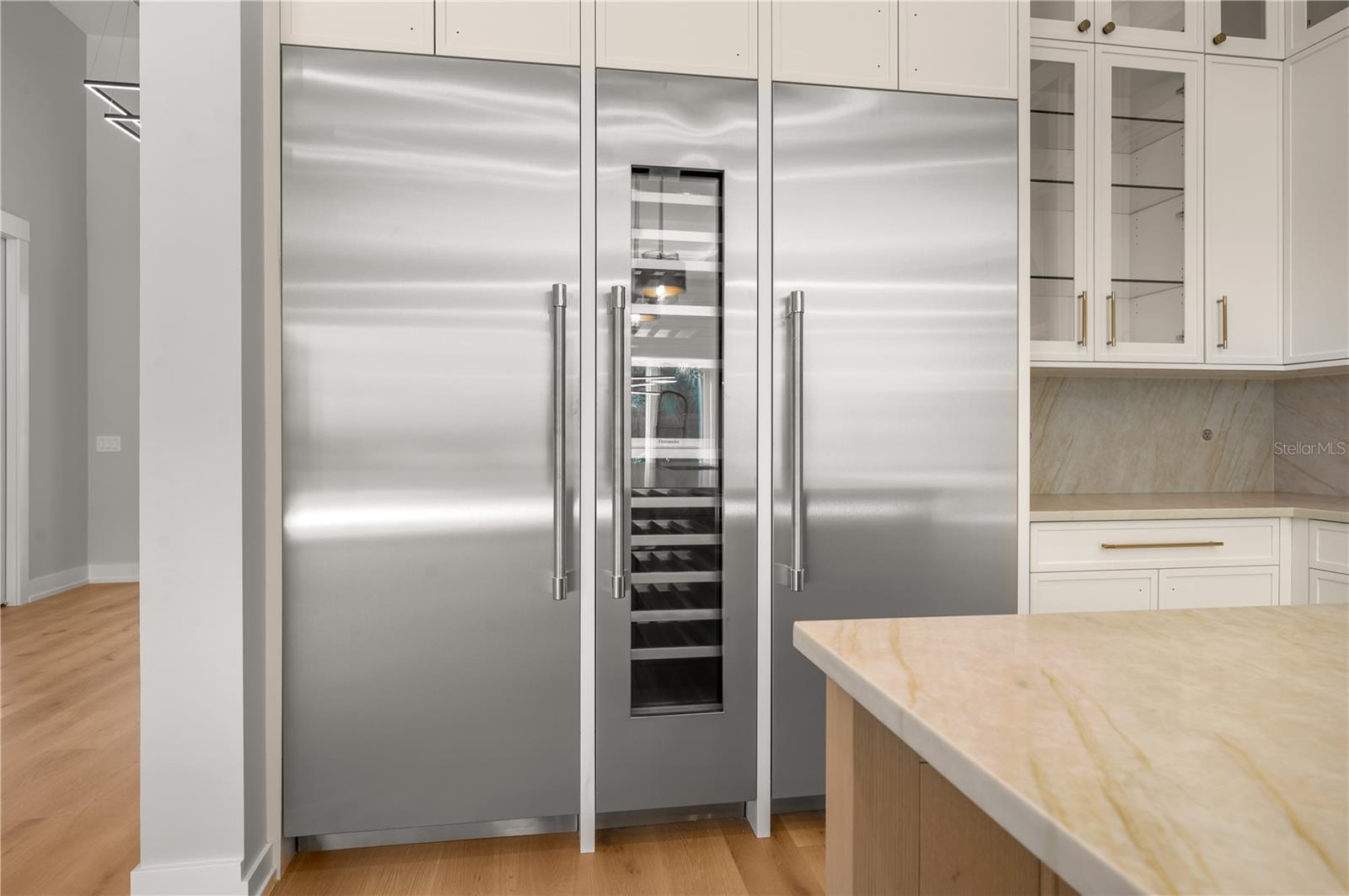 Refrigerator, wine fridge, and freezer.