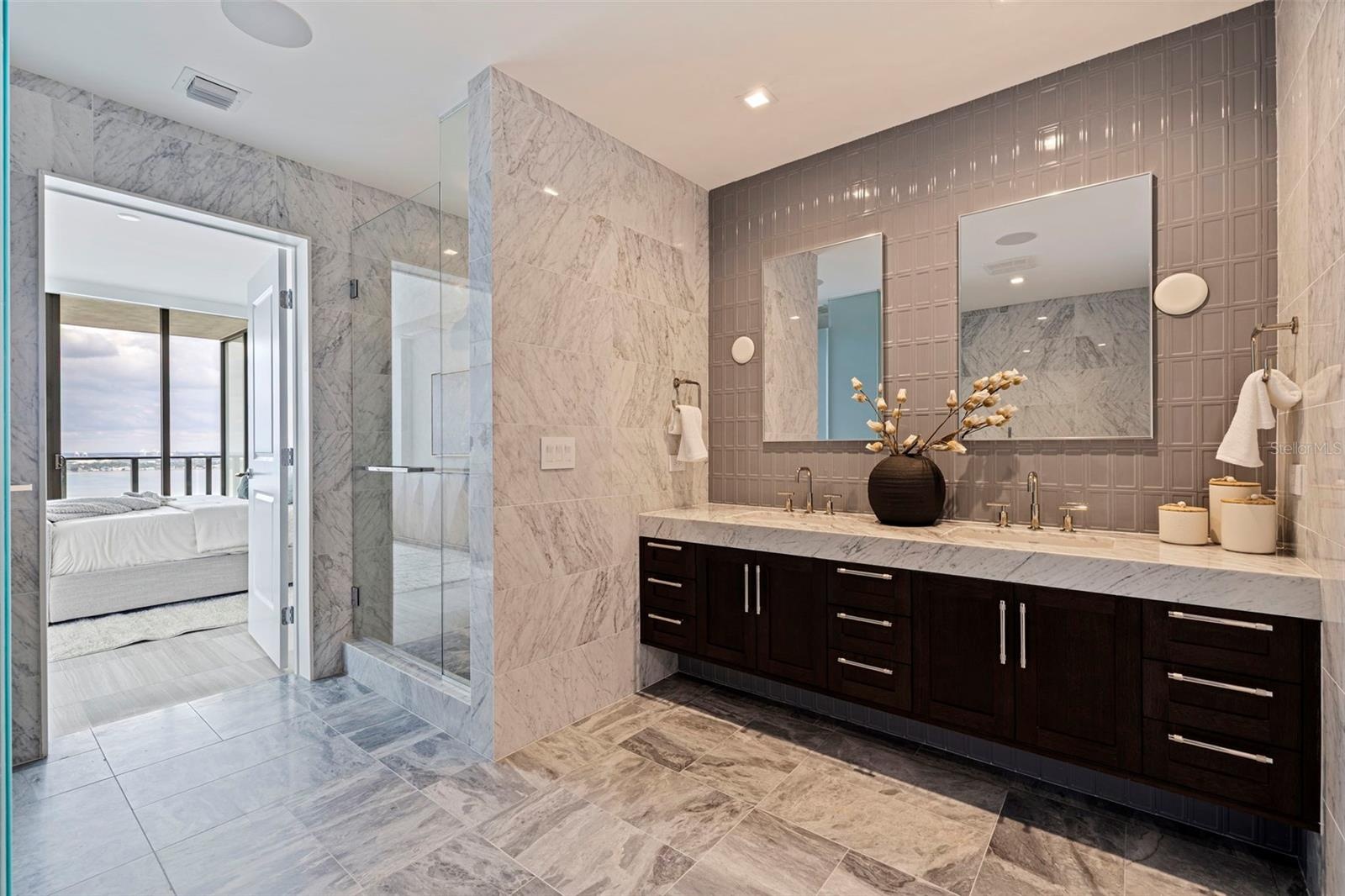 A spa-inspired primary bath wrapped in marble and refined finishes.