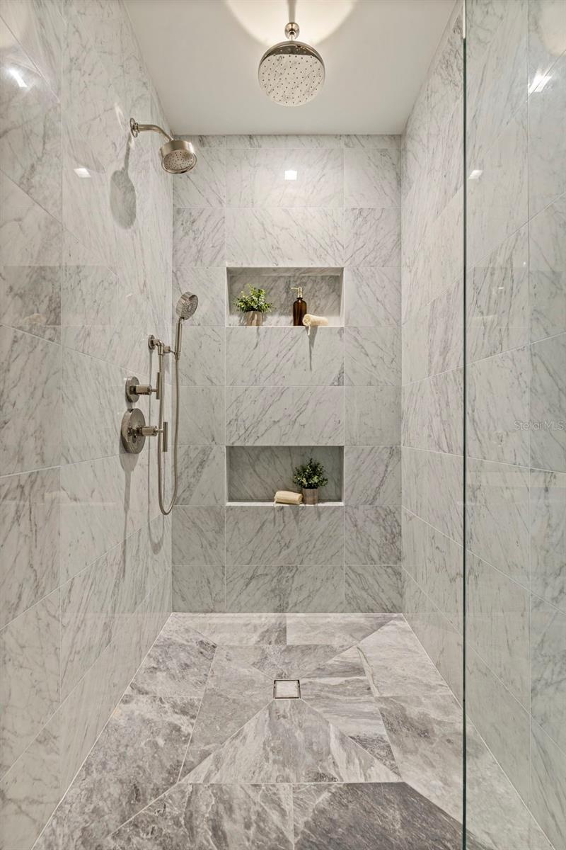An oversized marble shower designed with a true resort-level feel.