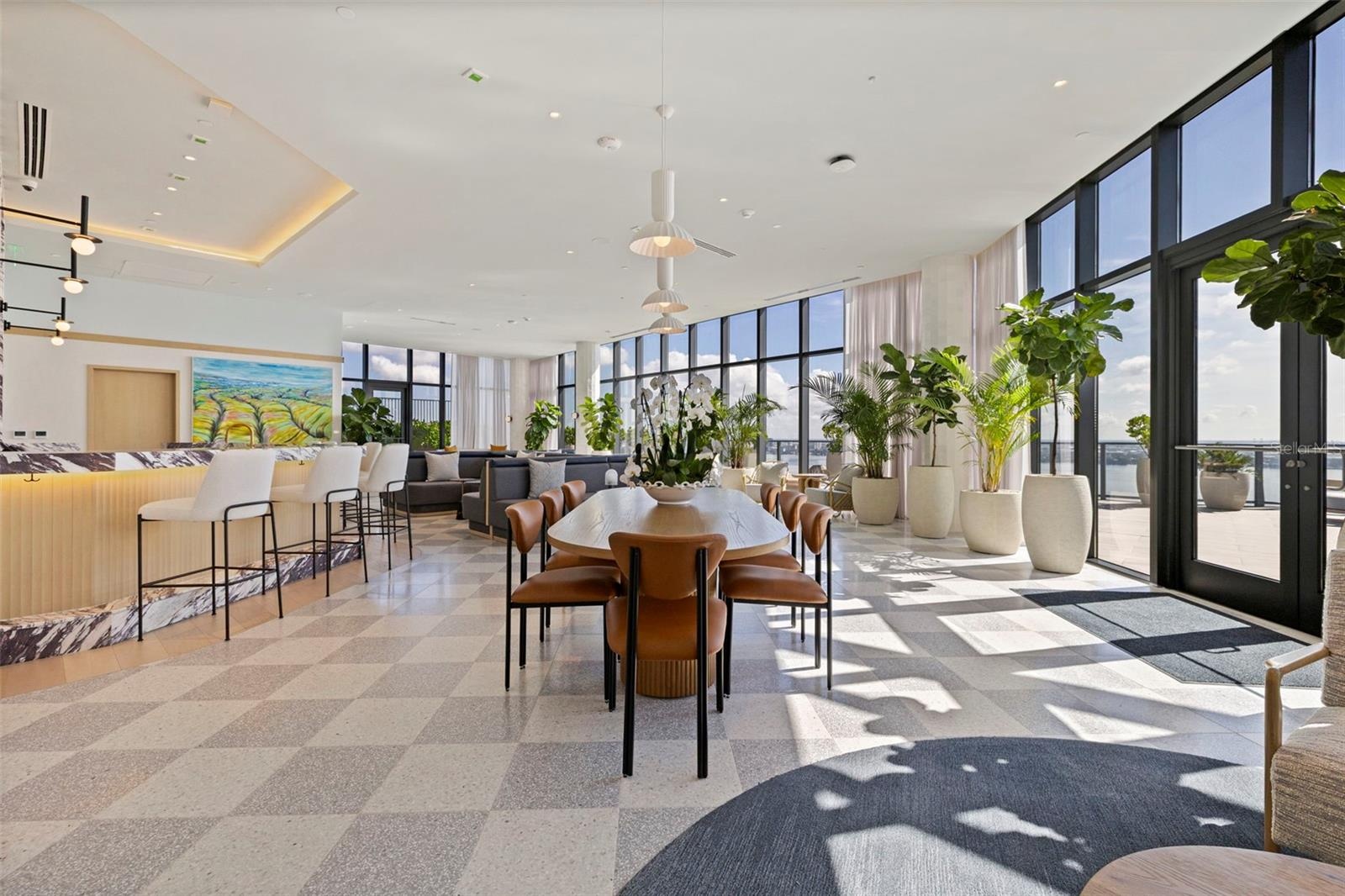 Floor-to-ceiling glass gives the social lounge a front-row seat to Tampa Bay.