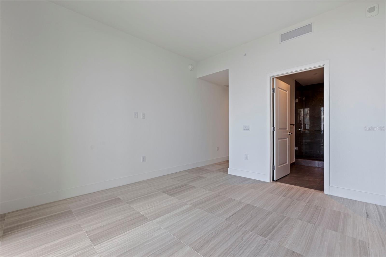 Bedroom 3 offers its own private bath, generous natural light, and a peaceful sense of separation.