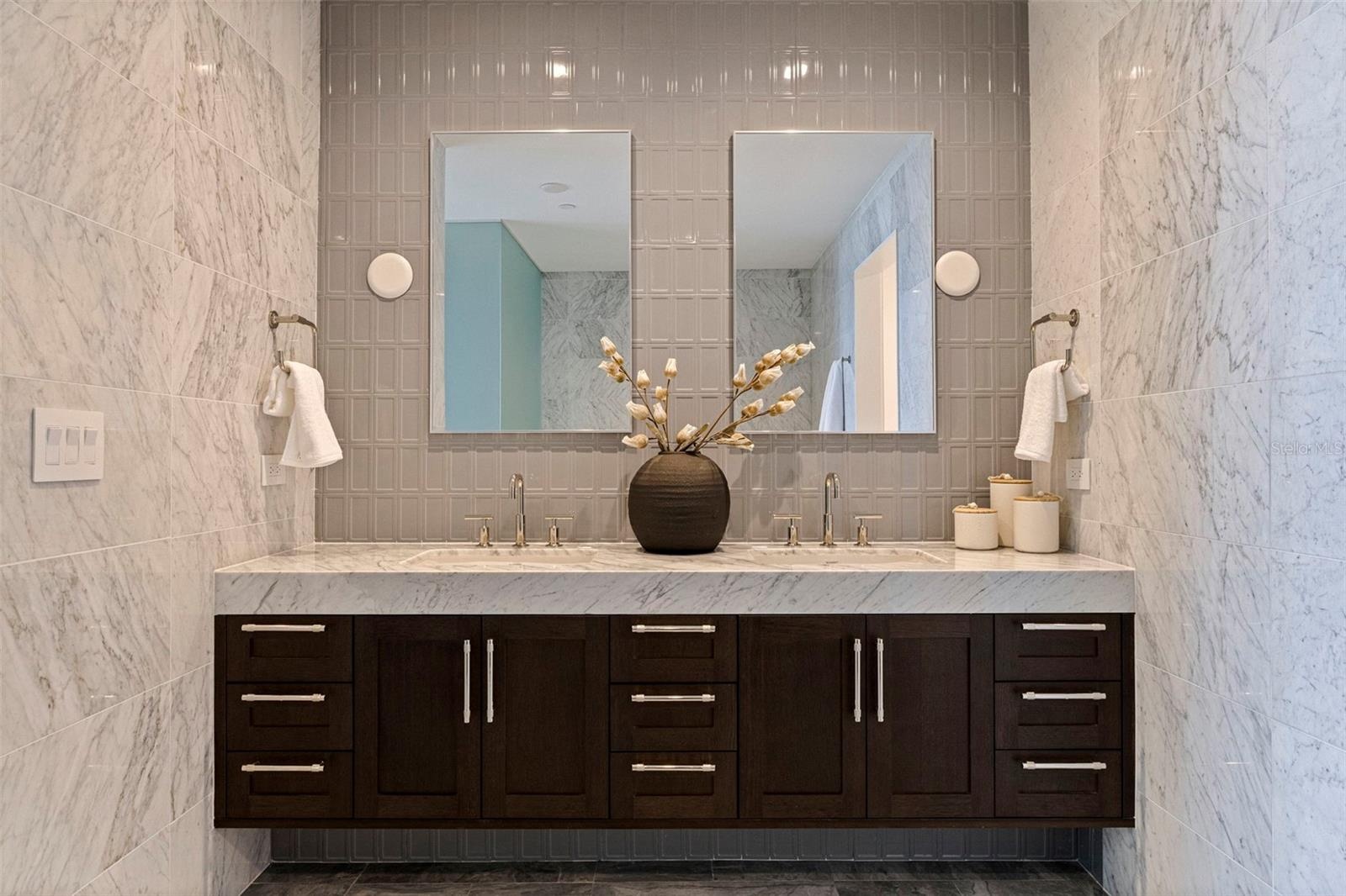 Dual vanities, marble surfaces, and elevated detail create a true retreat.