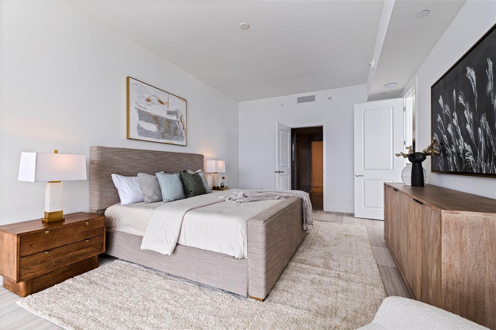 The primary suite balances quiet luxury with effortless connection to the view.