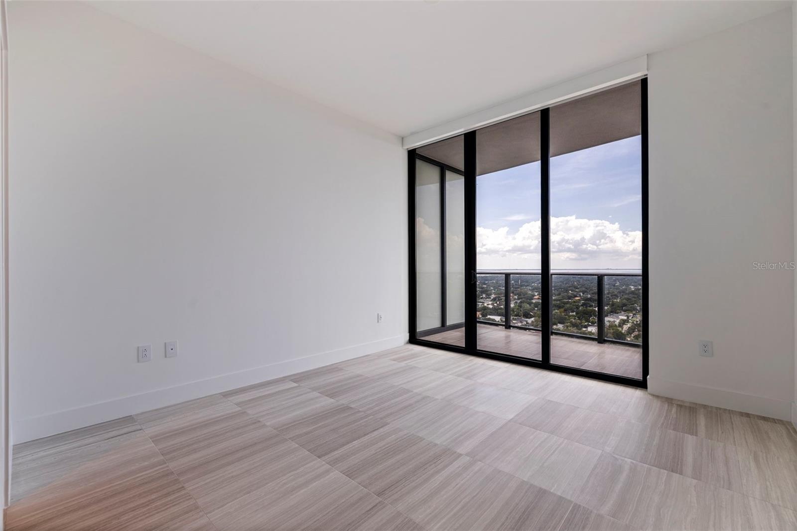 A second guest suite with direct balcony access and its own en-suite bath.