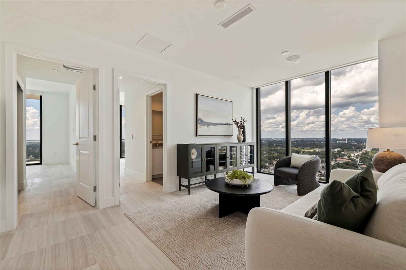 A second sitting area surrounded by light and expansive city views.