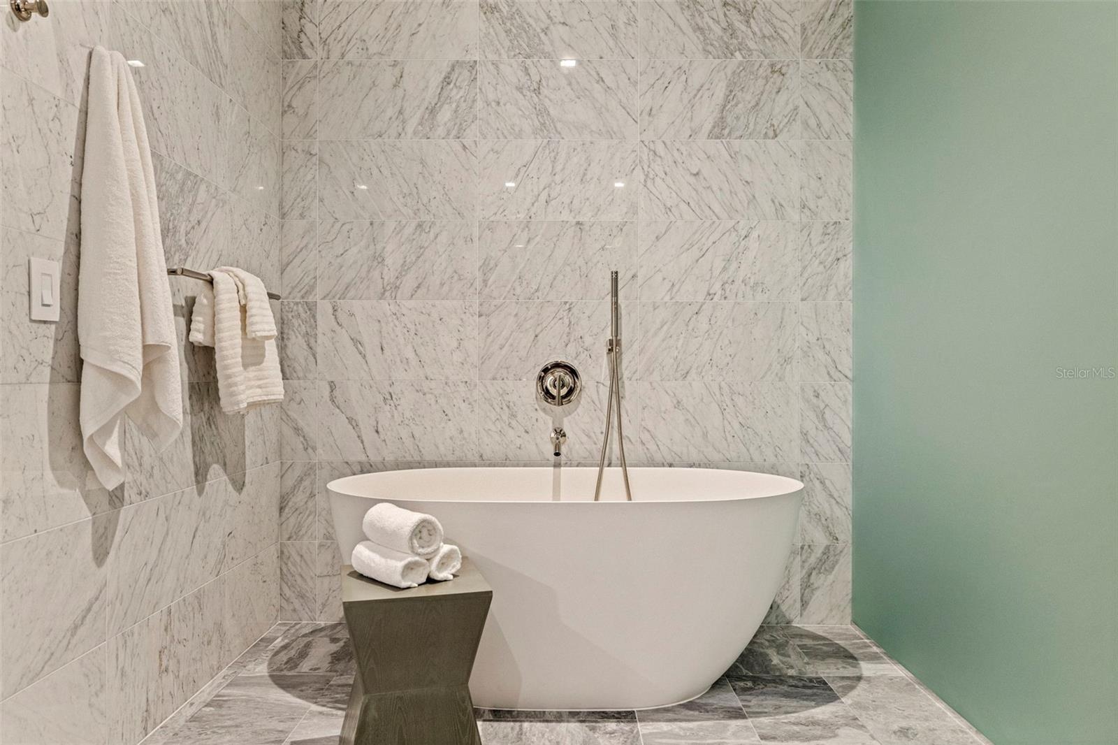 A sculptural soaking tub makes the primary bath feel distinctly spa-like.