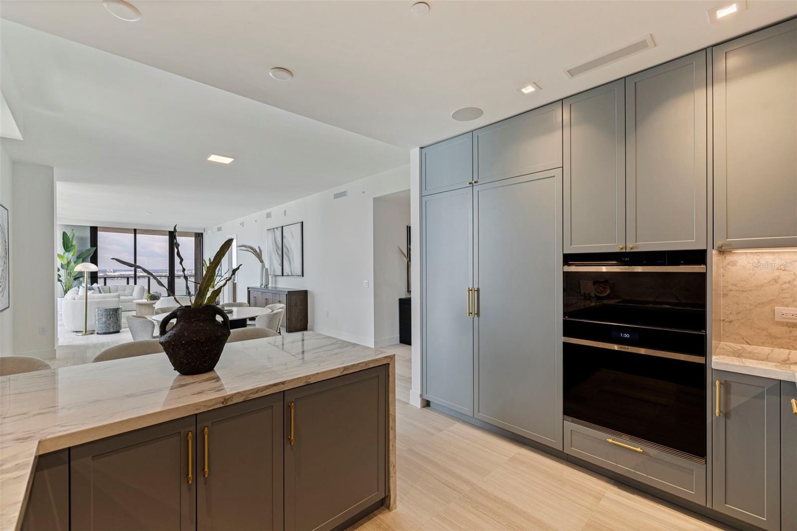 A chef-caliber kitchen with Sub-Zero and Wolf appliances, island wine refrigeration, and under-sink water purification.