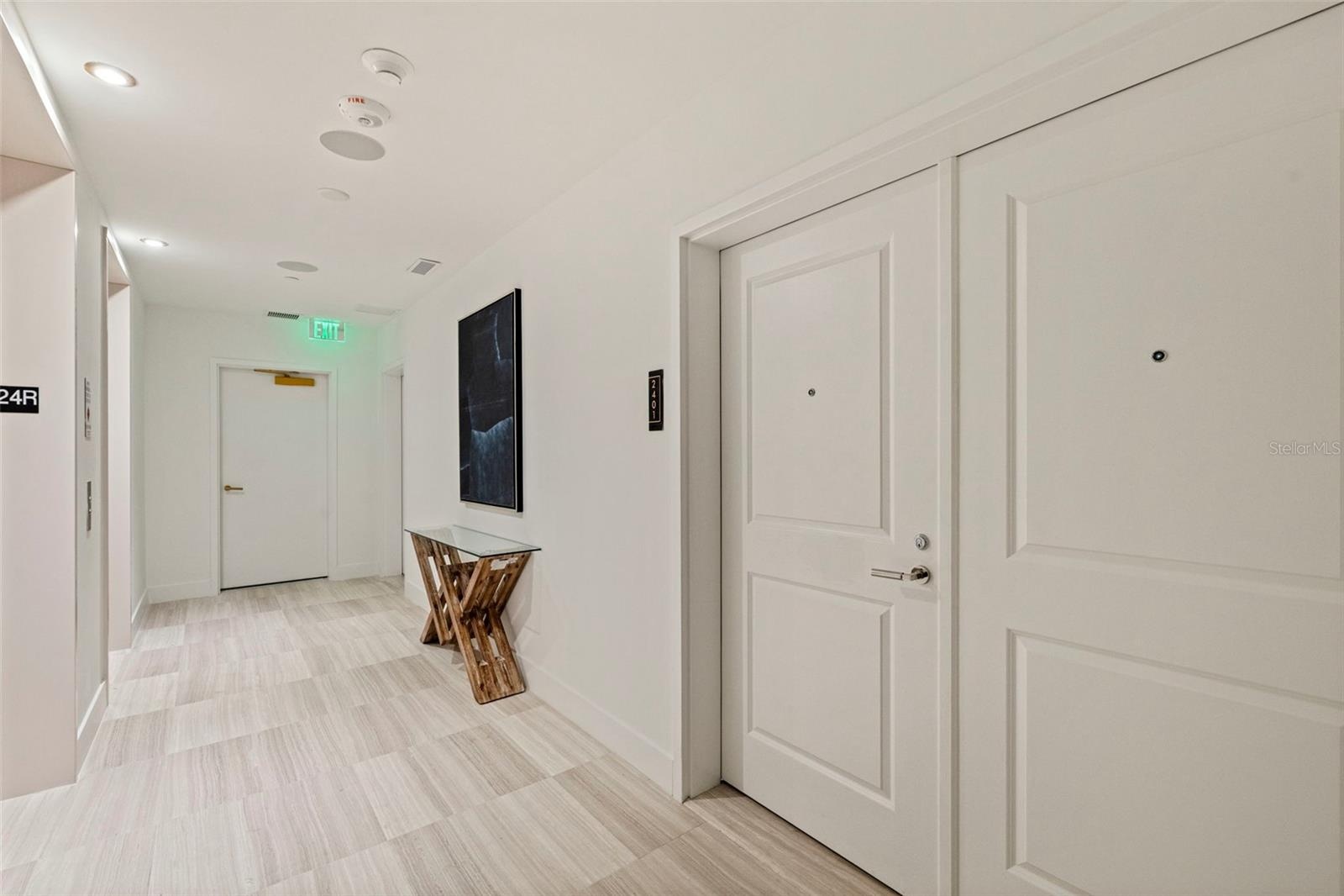 The private 24th-floor landing creates an arrival that feels discreet and distinctly residential.