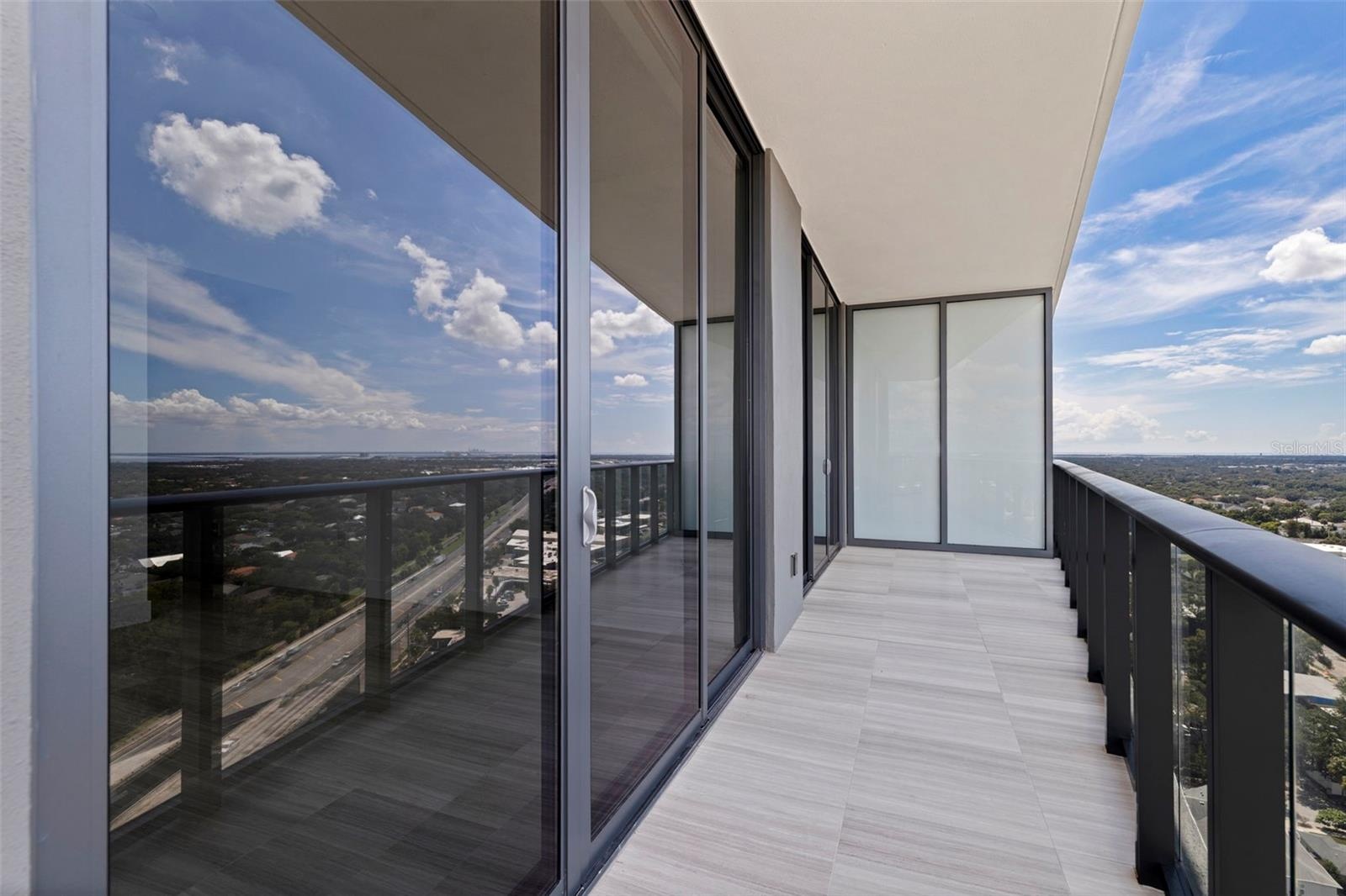 An expansive private balcony opens the home to sweeping views and fresh air high above Tampa.