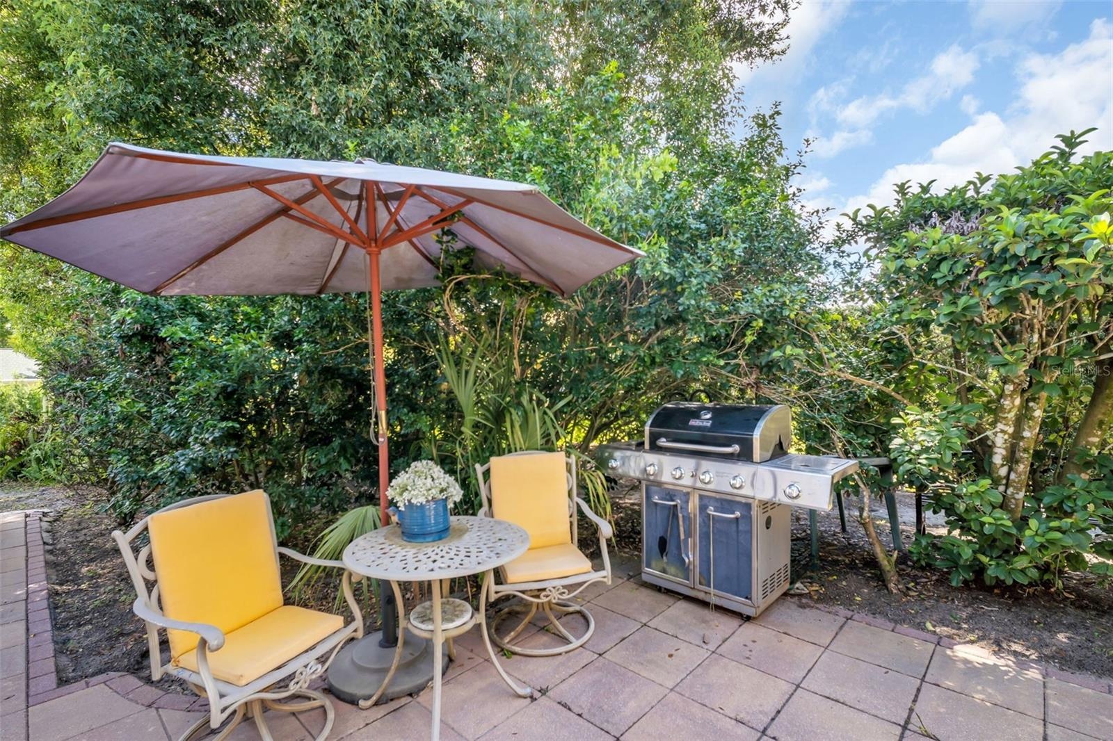 Additional patio space off the pool enclosure for furniture & grilling space~