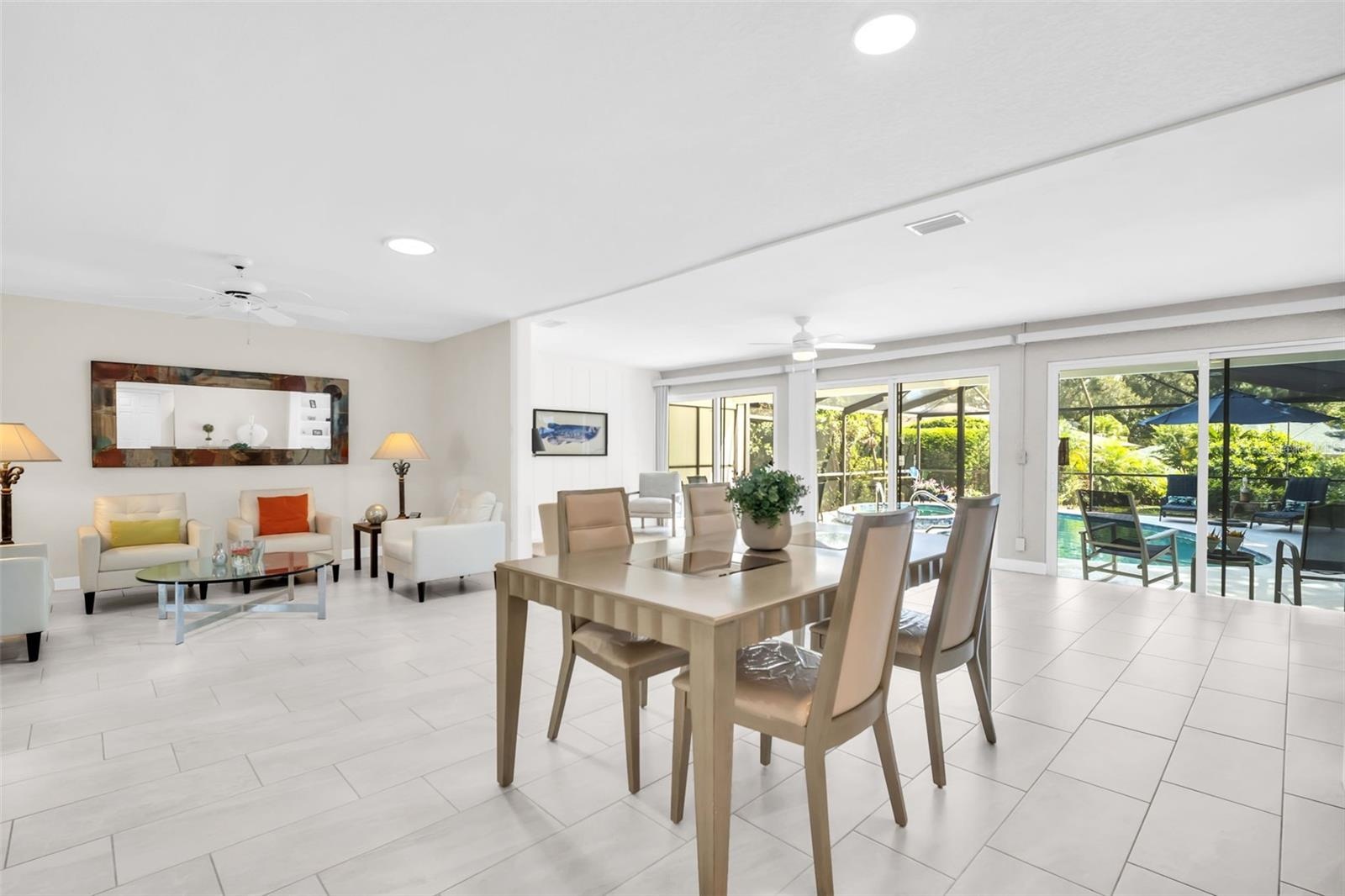 The perfect living/dining room combo with direct pool views through 3 massive glass sliders~