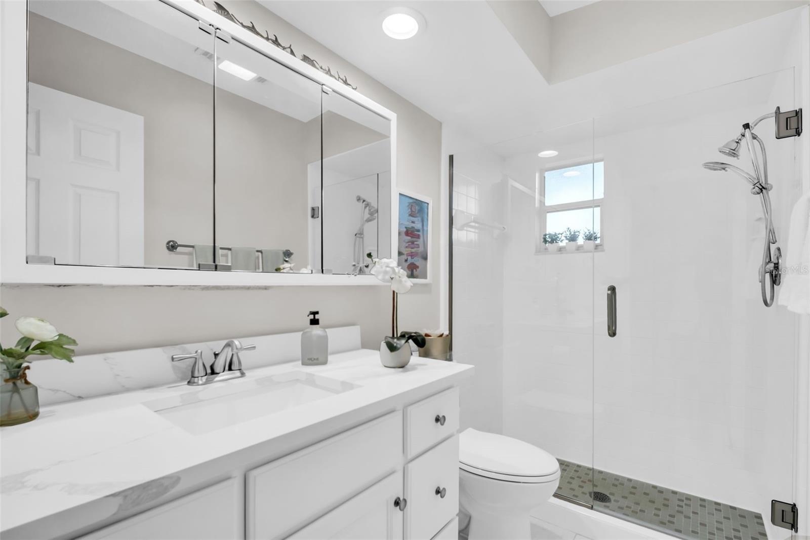 New vanity with stone top, fixtures, mirror, and recessed lighting~