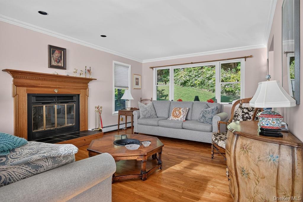 Bright living room with picture window and fireplace