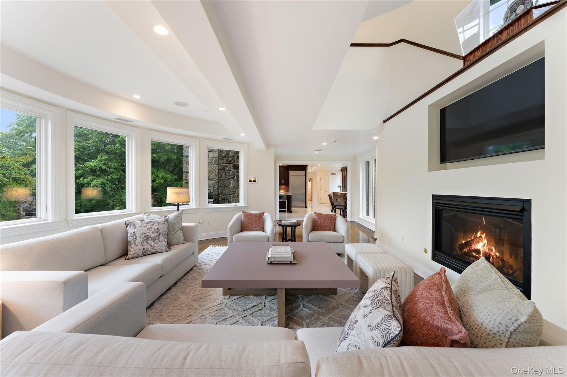 View of family room into kitchen with built in TV niche and Heatilator fireplace
