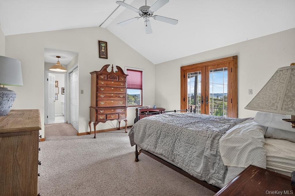 Vaulted ceilings in this lovely primary suite with Juliet balcony