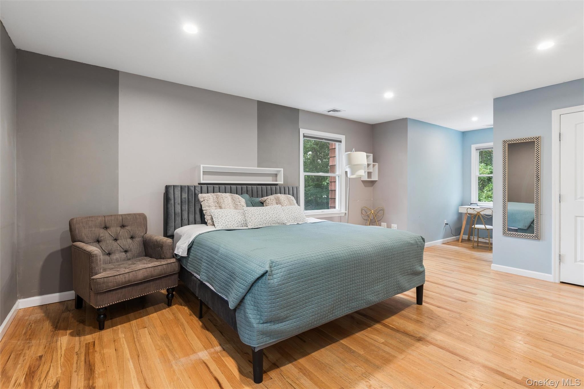 Wood-finish flooring, recessed lighting, and multiple windows