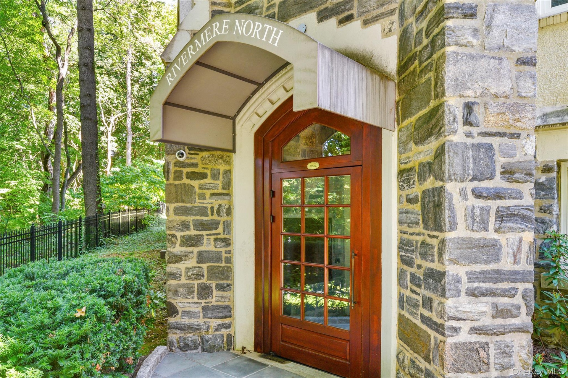 Entrance to property featuring stone siding