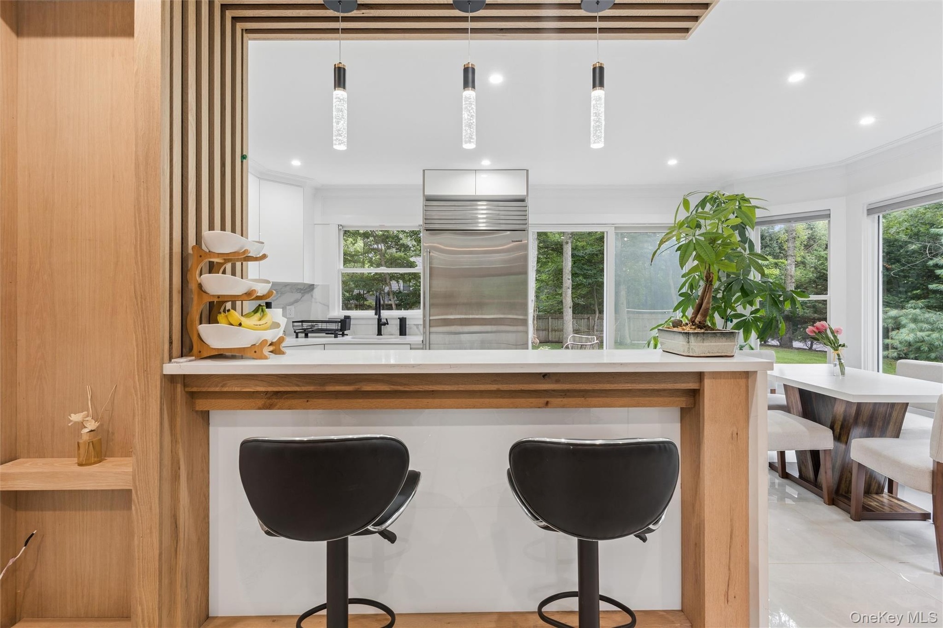 Kitchen pass-through featuring a wood-finish bar and white countertop