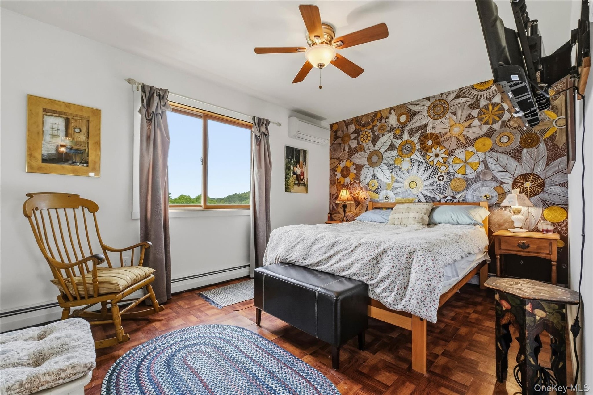 Primary bedroom w/hand-painted flower motif & mountain views.