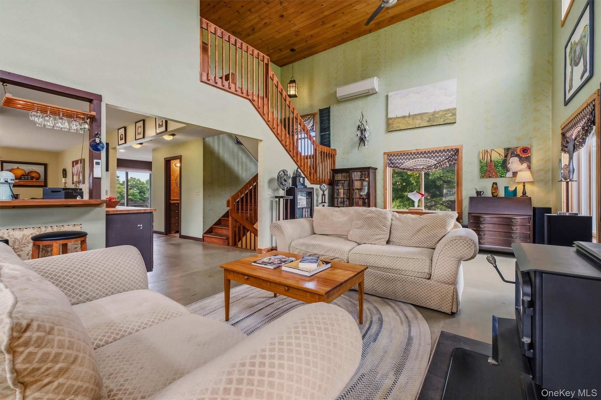 Soaring 17' pine ceilings in the dramatic great room .