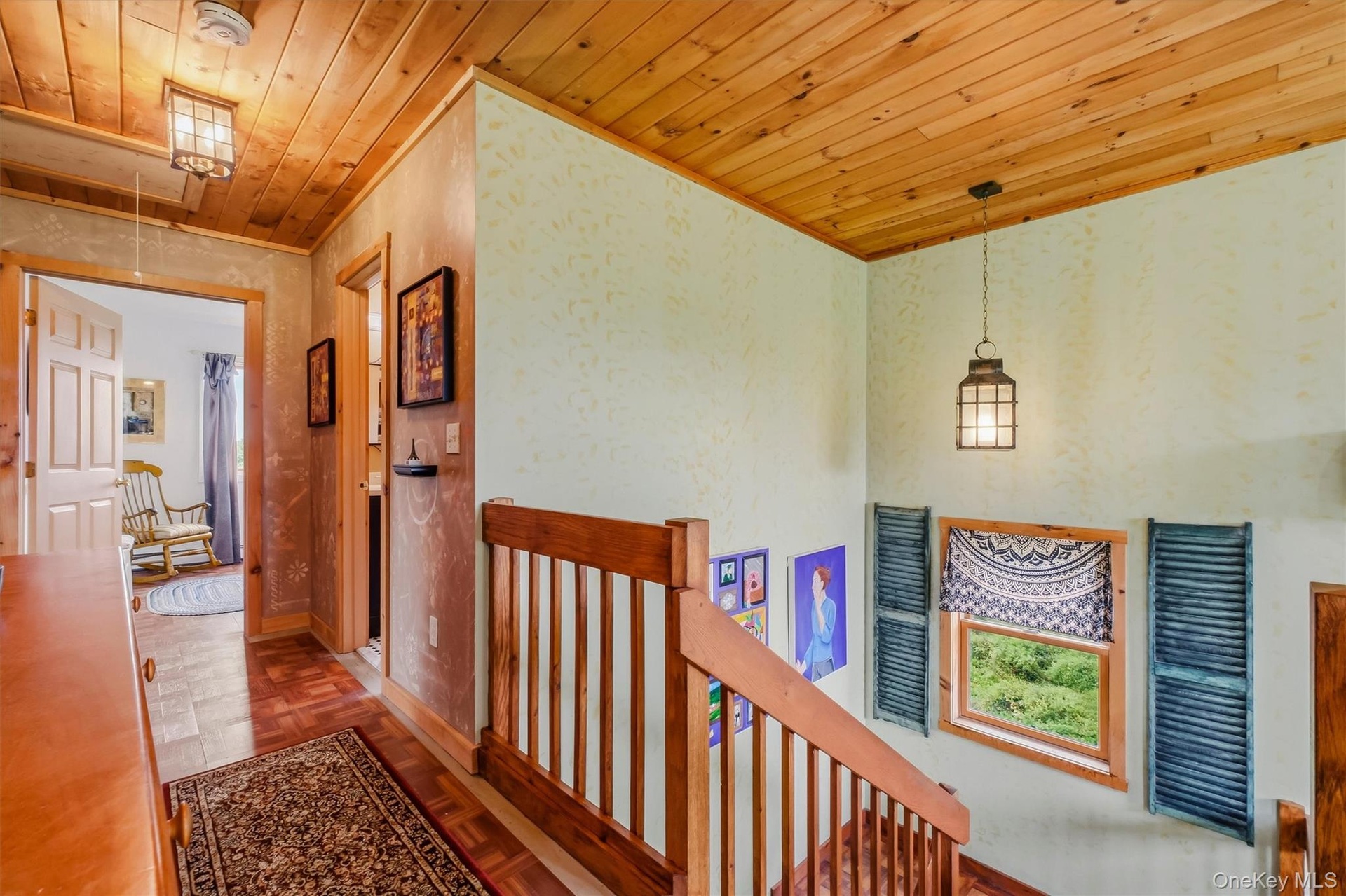 Stairway leading from main level to 2nd level w/pine ceilings