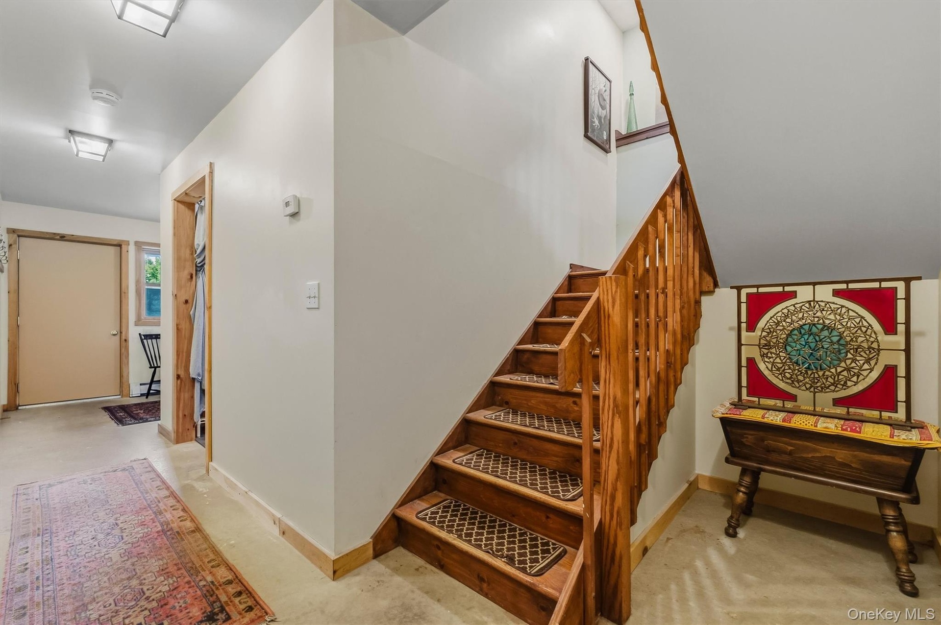 Stairwell from 2nd level to lower level. Home is open, spacious and has a good layout.